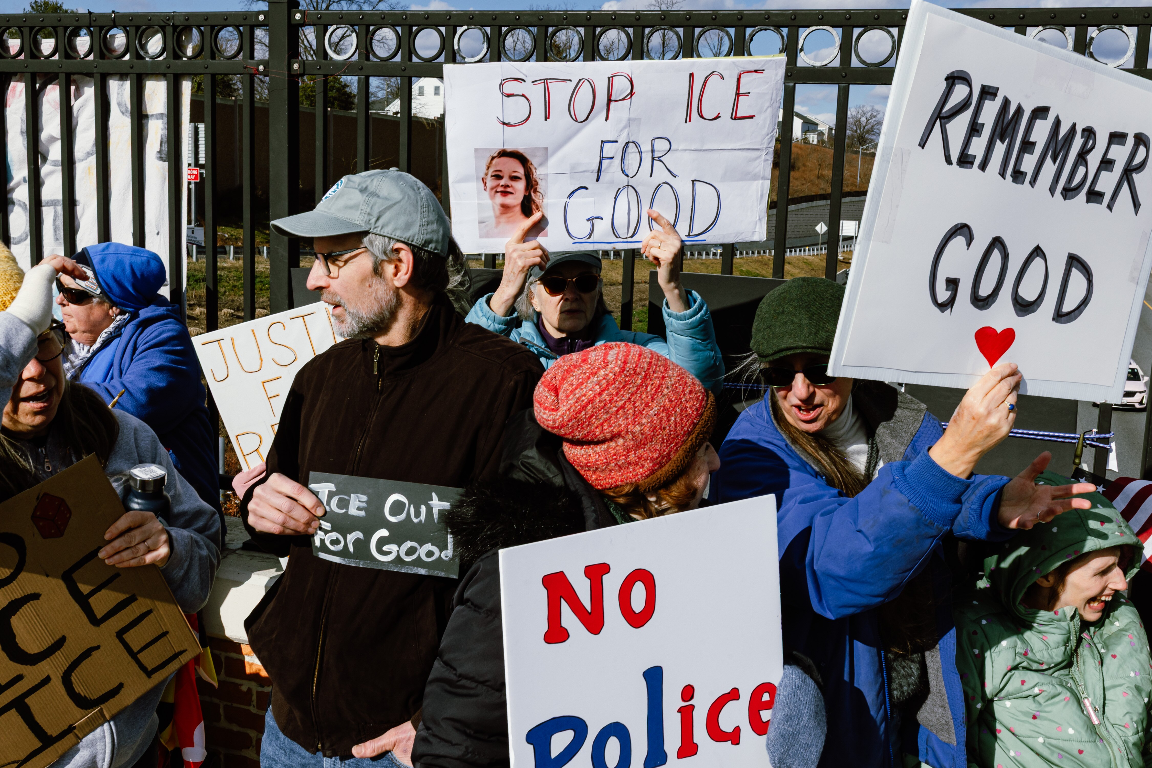 Demonstrators hold signs during an anti-ICE protest on the Frederick Road overpass above I-695 in Catonsville on Sunday.