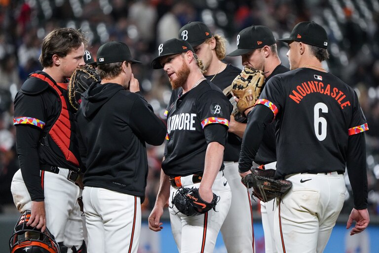 Baltimore Orioles pitcher Craig Kimbrel (middle) speaks with pitching coach Drew French and his other teammates during a mound meeting in game one of a series against the Oakland Athletics at Camden Yards on April 26, 2024.
