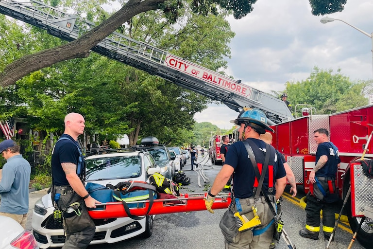 Two firefighters suffered minor injuries while battling a fire that spread through three rowhomes in Hampden on Saturday, July 12, 2026, the Baltimore City Fire Department said.