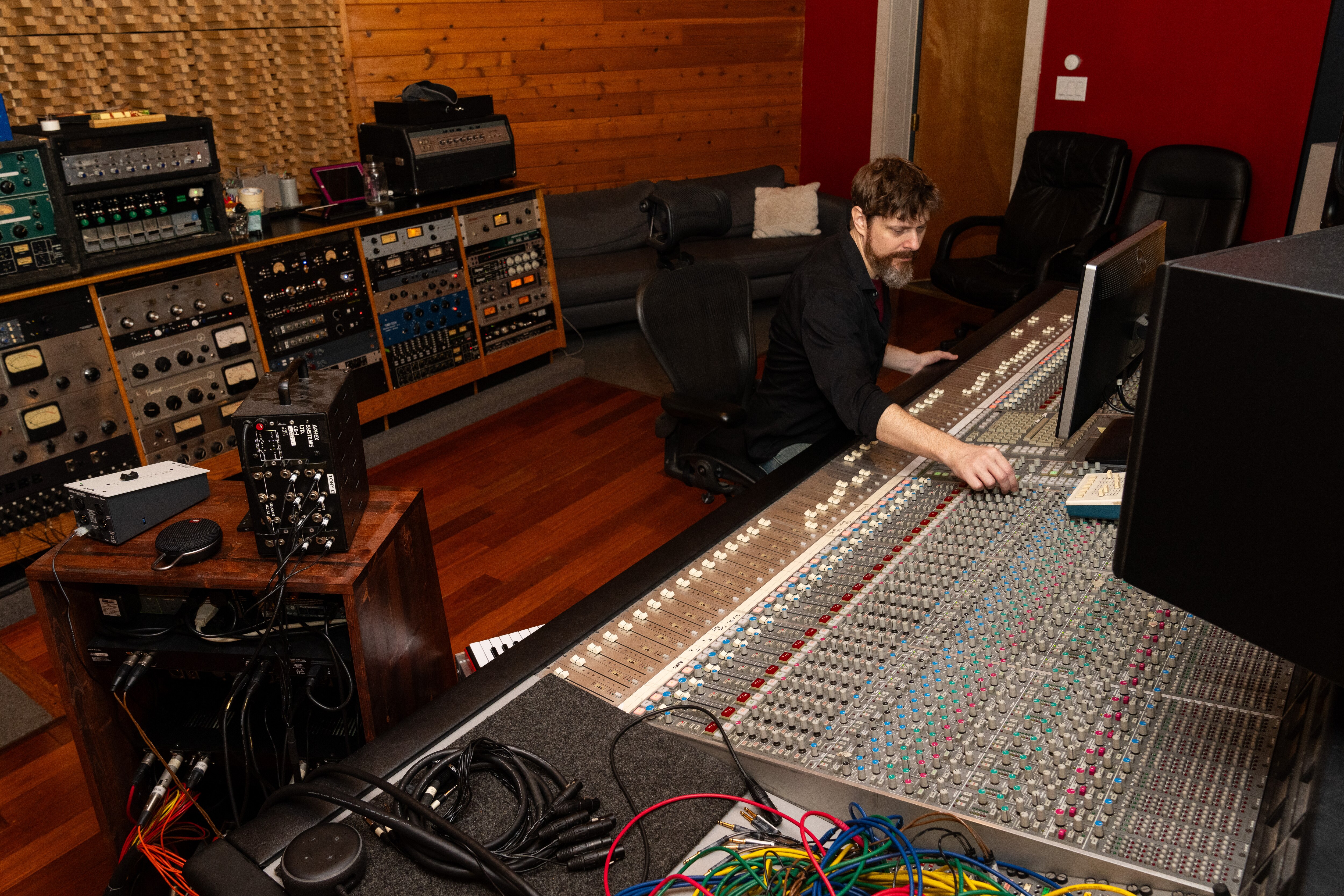 A wide shot of Studio A as Steve Wright uses the mixing console in the top right.