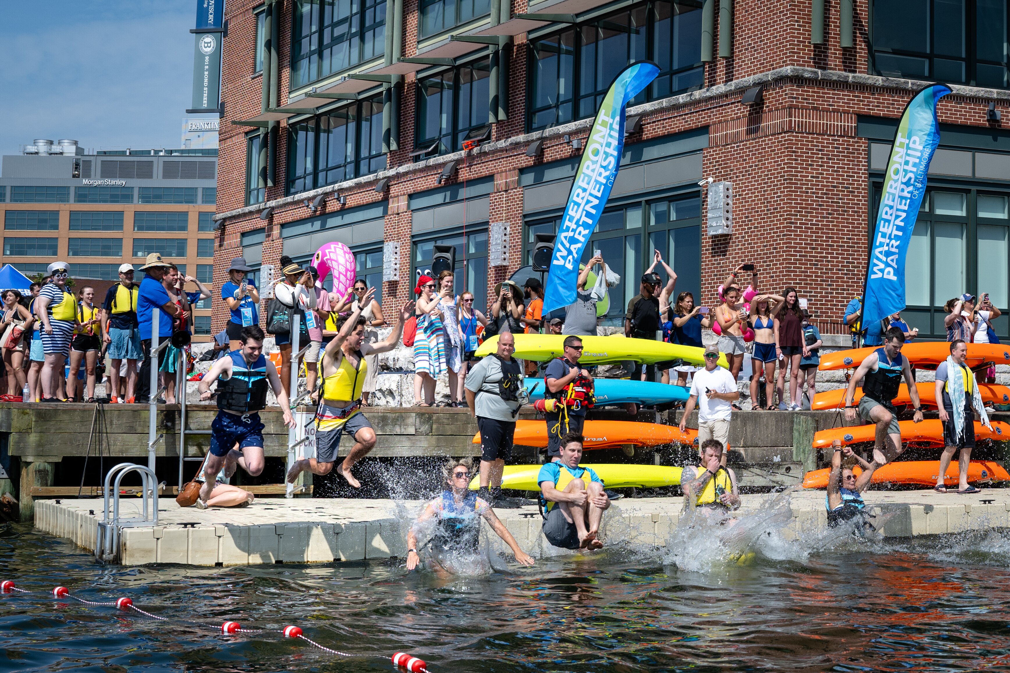 Baltimore Banner Giacomo "Jack" Bologna jumps into the Baltimore Harbor alongside other participants as a part of the Waterfront Partnership's Harbor Splash 2024 event held on 6/23/24 in Baltimore, MD.