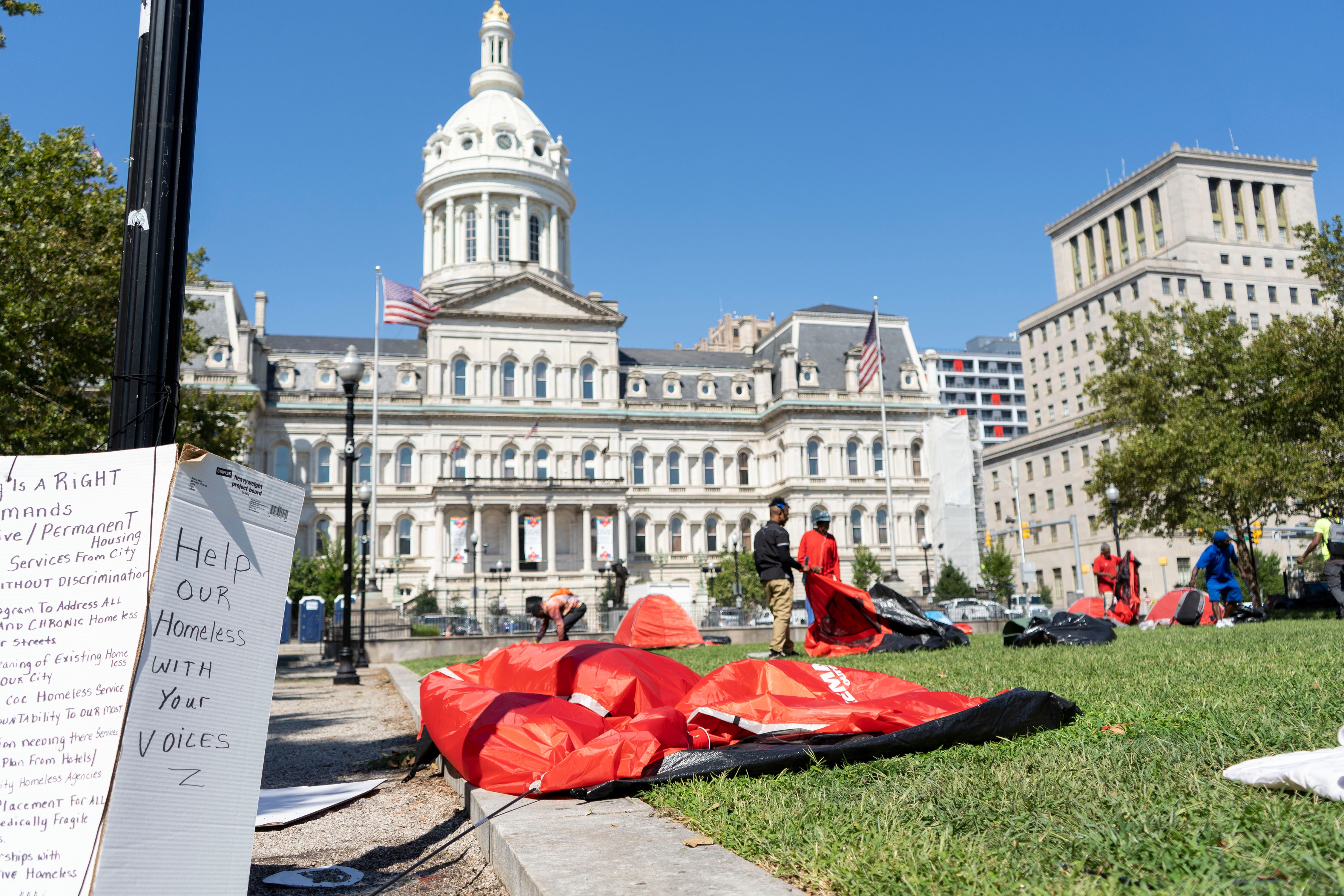 People remove tents at the homeless encampment on War Memorial Plaza August 19, 2022. The mayor's office told organizers and tent owners to remove their belongings because of an event scheduled on the plaza.