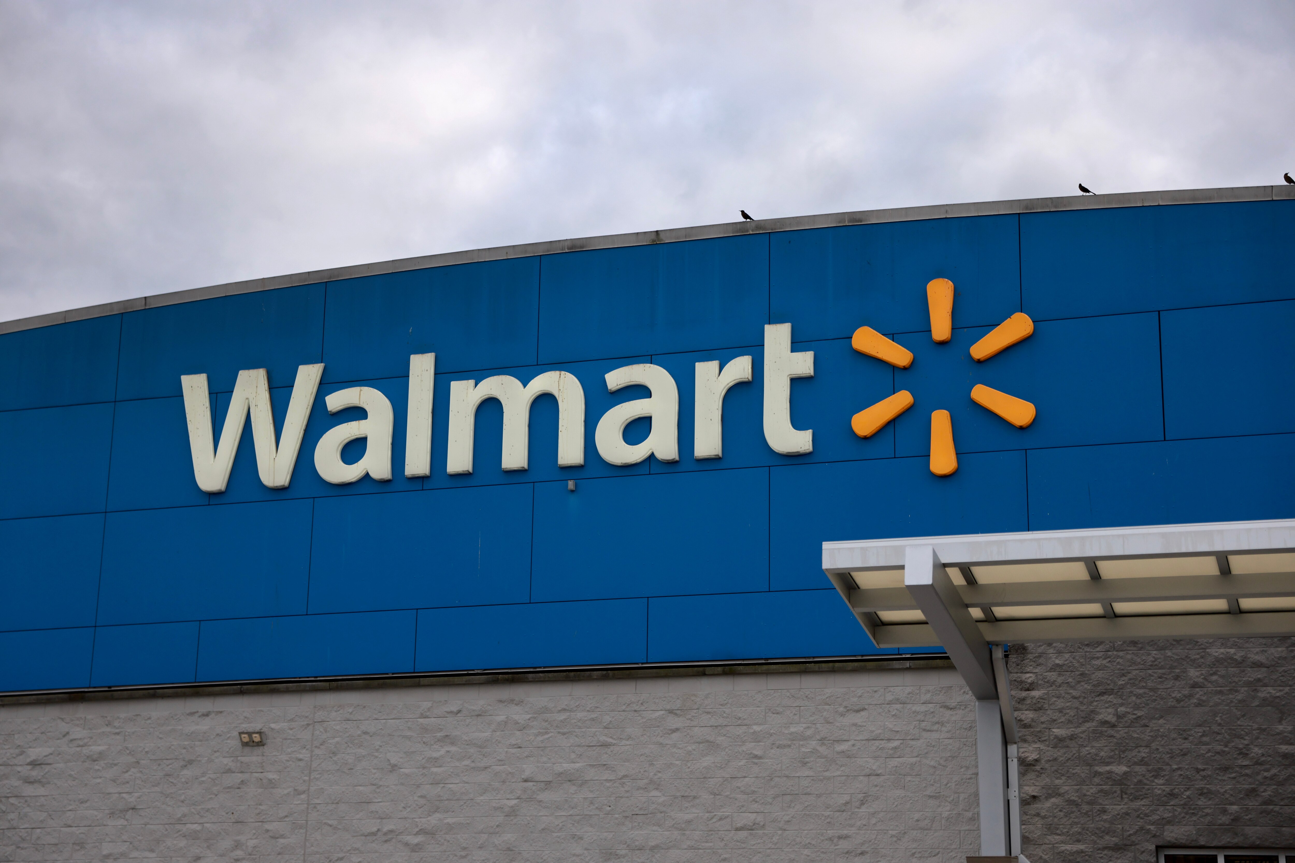 MIAMI, FLORIDA - NOVEMBER 18: A Walmart sign is displayed outside a Supercenter on November 18, 2024 in Miami, Florida. Walmart is set to report its third-quarter results on Tuesday, Nov. 19th. (Photo by Joe Raedle/Getty Images)