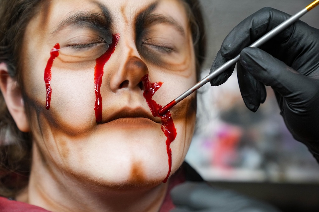 Makeup artist Becca Hammersla applies fake blood to Banner reporter Hannah Yasharoff in the makeup department at Markoff's Haunted Forest in Dickerson, Md. on Friday, October 9, 2026.