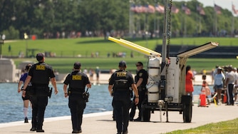 Oklahoma City Police Department officers, deputized to assist with local law enforcement for events around the 250th anniversary of the U.S., patrol near the area where sections of blue coating have peeled up in the Lincoln Memorial Reflecting Pool, Saturday, June 20, 2026, in Washington. (AP Photo/Mark Schiefelbein)