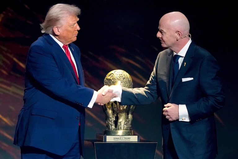 FIFA President Gianni Infantino, right, awards President Donald Trump with the FIFA Peace Prize during the draw for the 2026 soccer World Cup at the Kennedy Center in Washington, Dec. 5, 2025.