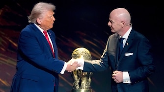 FIFA President Gianni Infantino, right, awards President Donald Trump with the FIFA Peace Prize during the draw for the 2026 soccer World Cup at the Kennedy Center in Washington, Dec. 5, 2025.