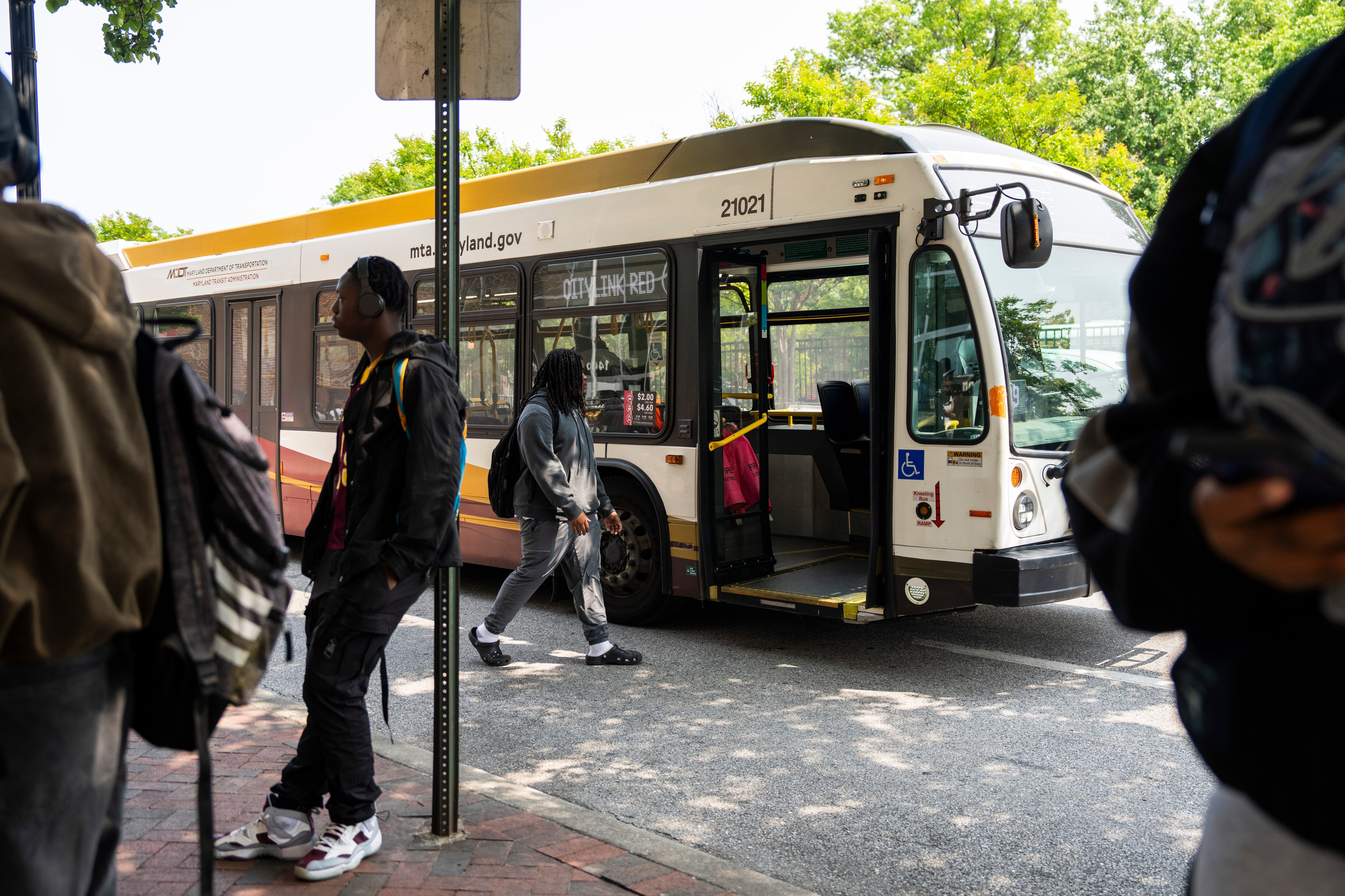 Baltimore city buses pick up students outside Dunbar High School in June.