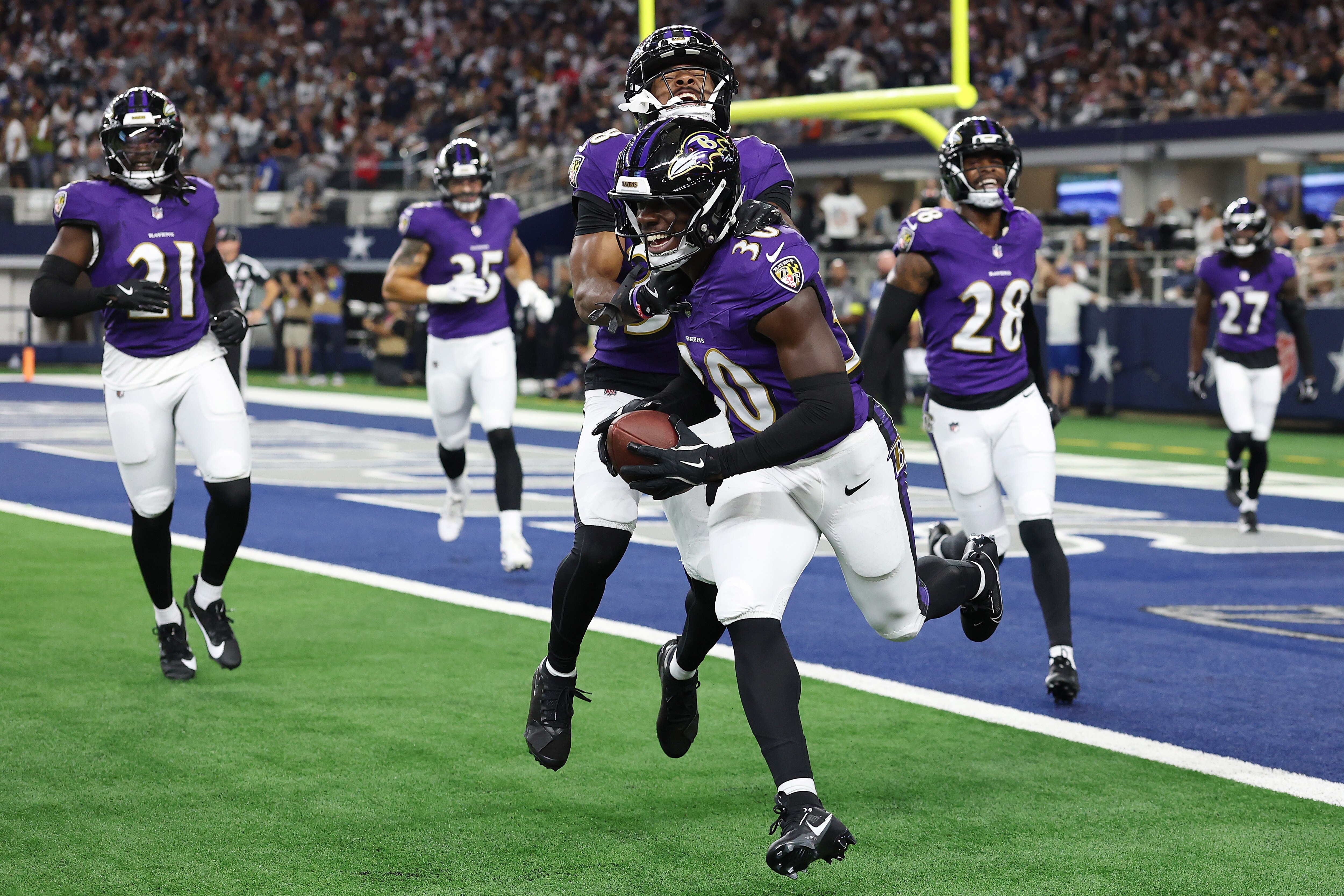 Reuben Lowery celebrates an interception near the end of the first half Saturday night against the Cowboys.