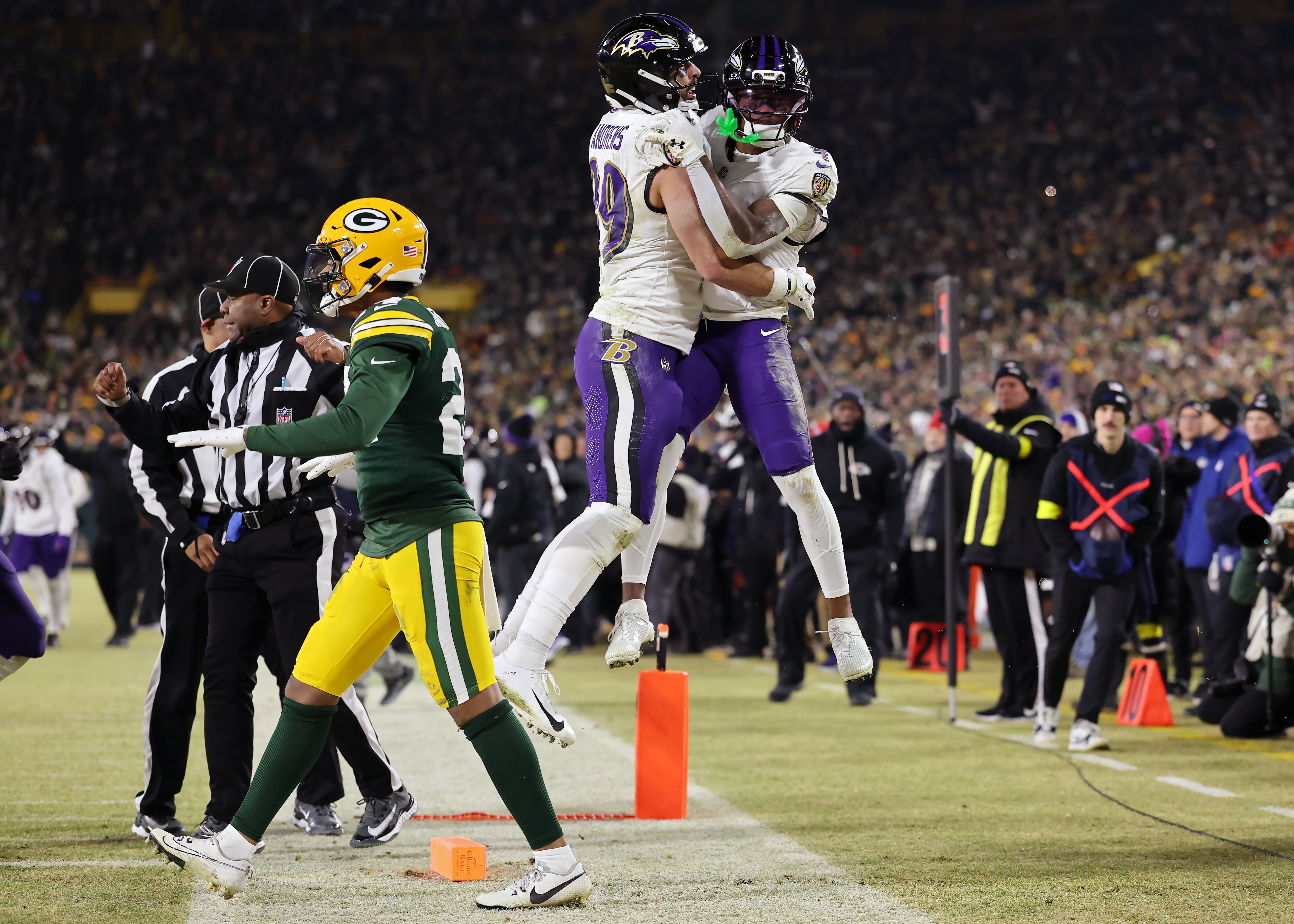Mark Andrews #89 and Zay Flowers #4 of the Baltimore Ravens celebrate after Flowers scored a touchdown in the fourth quarter against the Green Bay Packers at Lambeau Field on December 27, 2025 in Green Bay, Wisconsin.