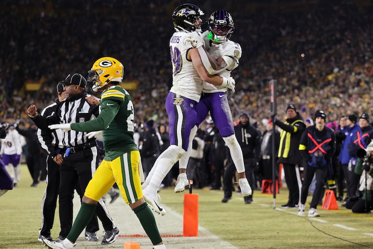 Mark Andrews #89 and Zay Flowers #4 of the Baltimore Ravens celebrate after Flowers scored a touchdown in the fourth quarter against the Green Bay Packers at Lambeau Field on December 27, 2025 in Green Bay, Wisconsin.