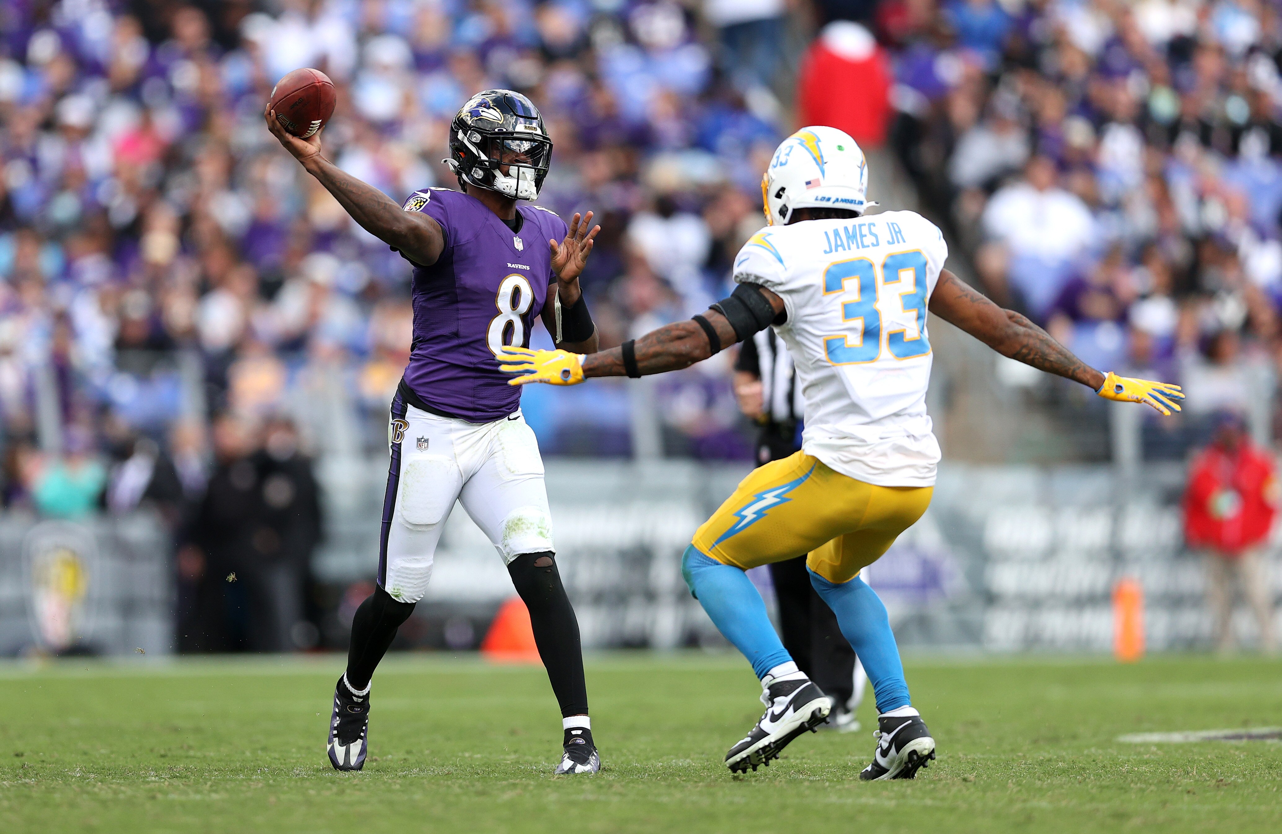 Ravens quarterback Lamar Jackson passes under pressure from the Chargers' Derwin James Jr. during Los Angeles' visit to Baltimore in 2021.