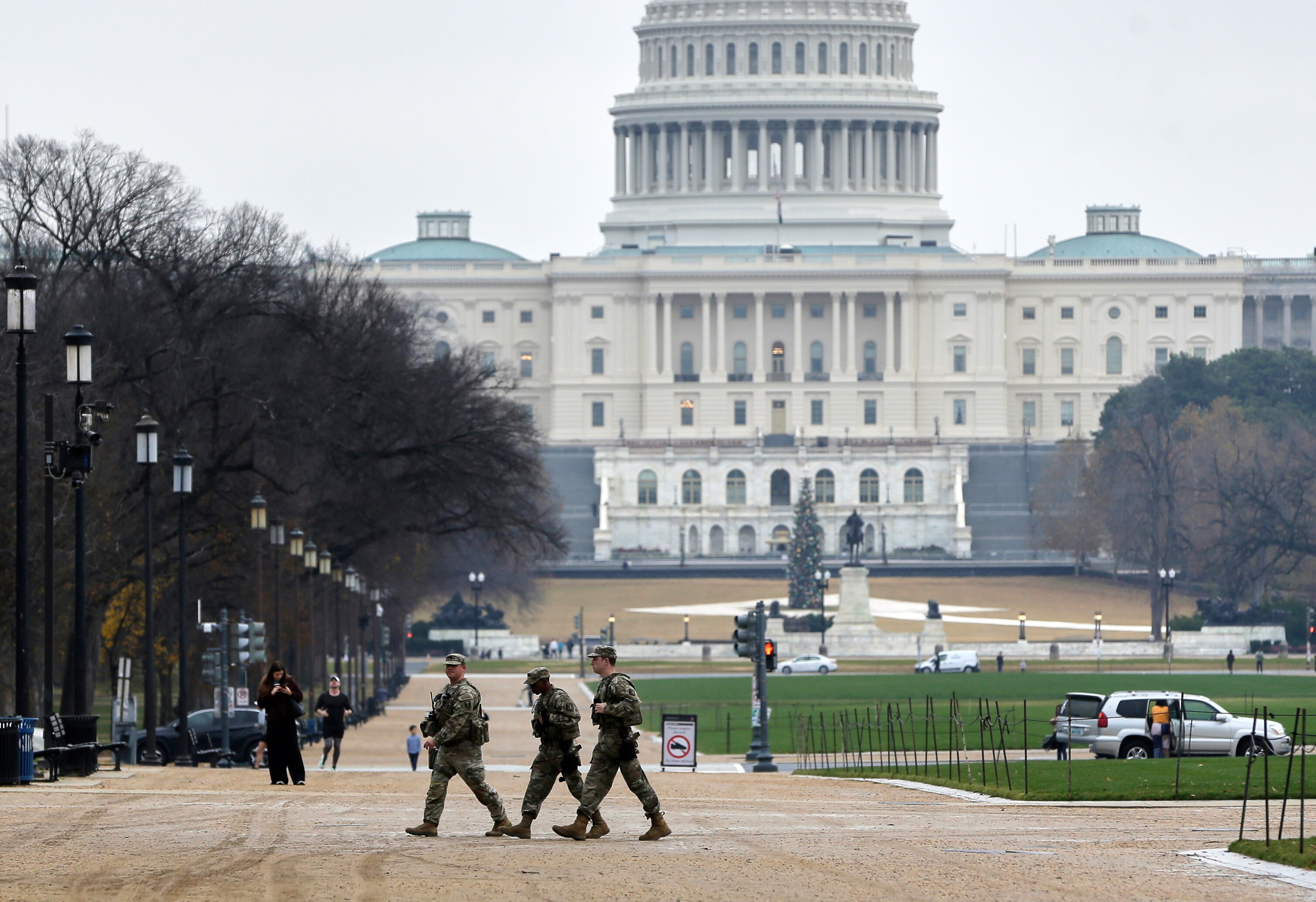 National Guard patrol on the National Mall near the U.S. Capitol, Wednesday, Nov. 26, 2025, in Washington. (AP Photo/Rahmat Gul)