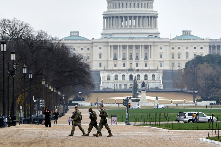 National Guard patrol on the National Mall near the U.S. Capitol, Wednesday, Nov. 26, 2025, in Washington. (AP Photo/Rahmat Gul)