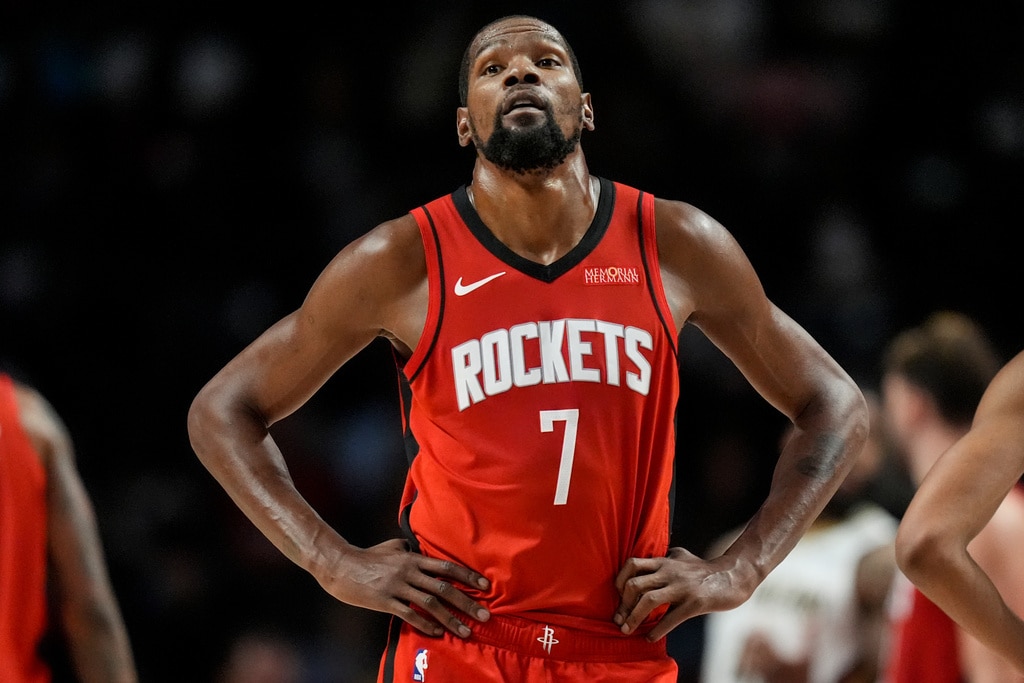 Houston Rockets forward Kevin Durant, in his Rockets uniform, with his hands resting on his hips during a game.
