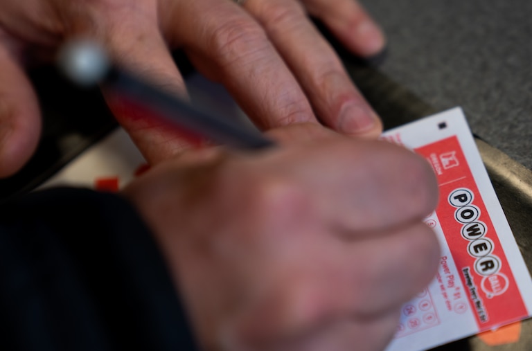 A person fills out a Powerball lottery ticket on Monday, Dec. 22, 2025, in Portland, Ore. (AP Photo/Jenny Kane)