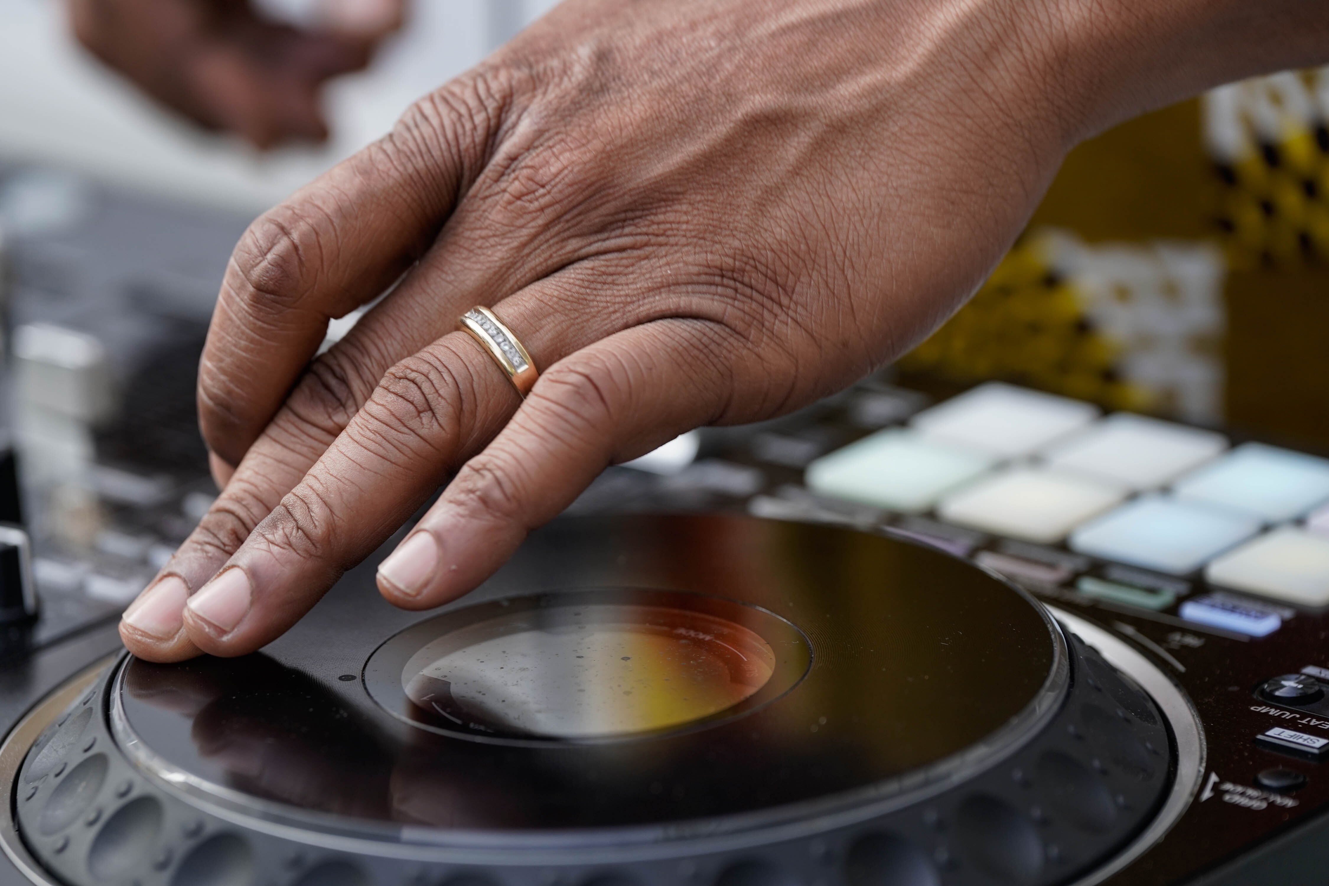 Kendrick Tilghman spins his audio deck at Malcolm Ruff’s annual Juneteenth celebration in 2023.