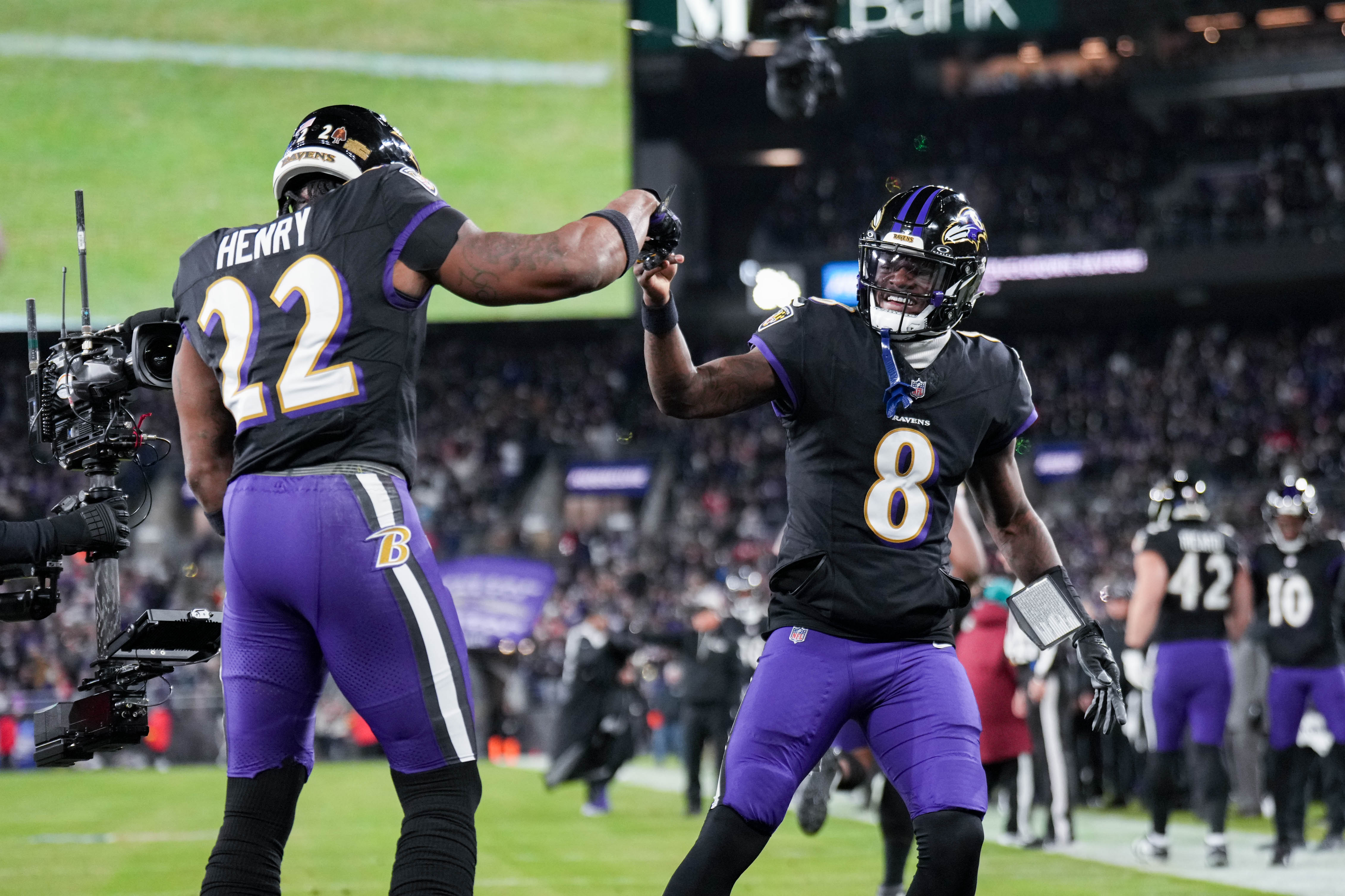 Ravens running back Derrick Henry celebrates with quarterback Lamar Jackson after rushing for a touchdown in the first quarter against the New England Patriots in December.