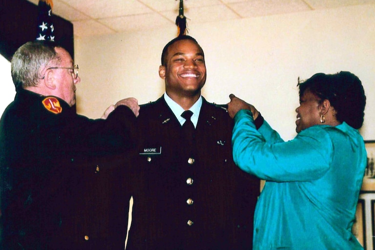 Wes Moore, 19, becoming an army officer. His mother, right, and mentor LTC Murnane pin on his bars.