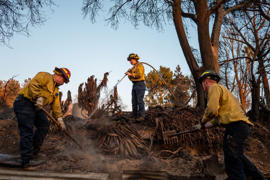 Firefighters with the Middleton Star Fire District work to clear hotspots on January 19, 2025 in Altadena, California.