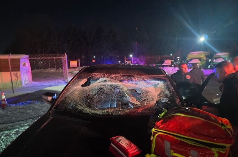 A black car with a shattered windshield