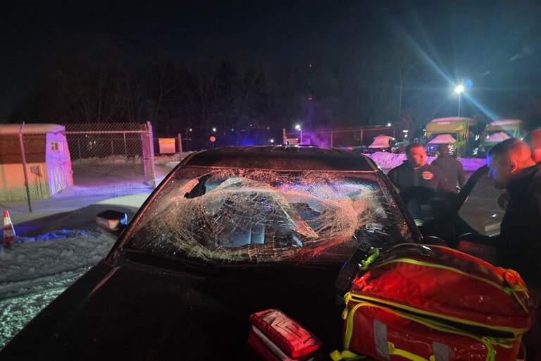 A black car with a shattered windshield