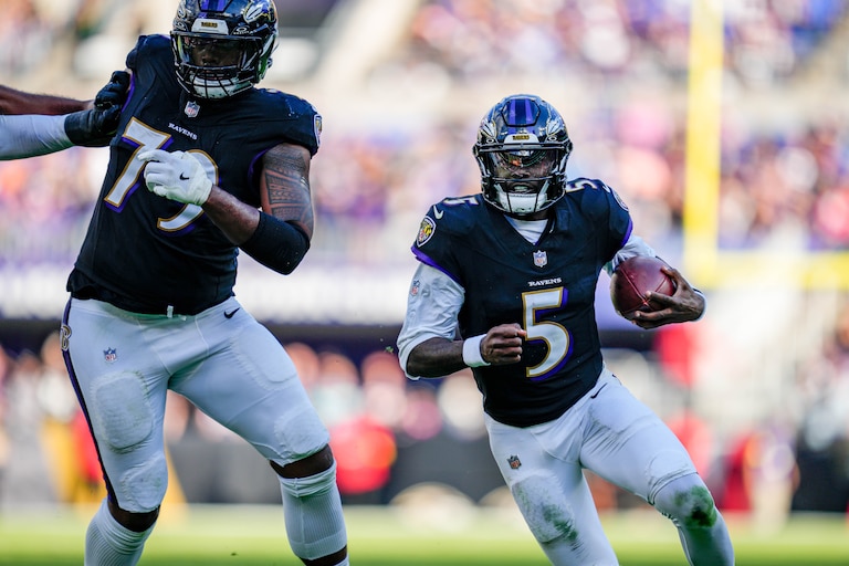 Baltimore Ravens quarterback Tyler Huntley (5) rushes forward, guarded by offensive lineman Ronnie Stanley (79), for a gain in the fourth quarter of a game against the Chicago Bears at M&T Bank Stadium in Baltimore, Md., on Sunday, Oct. 26, 2025.