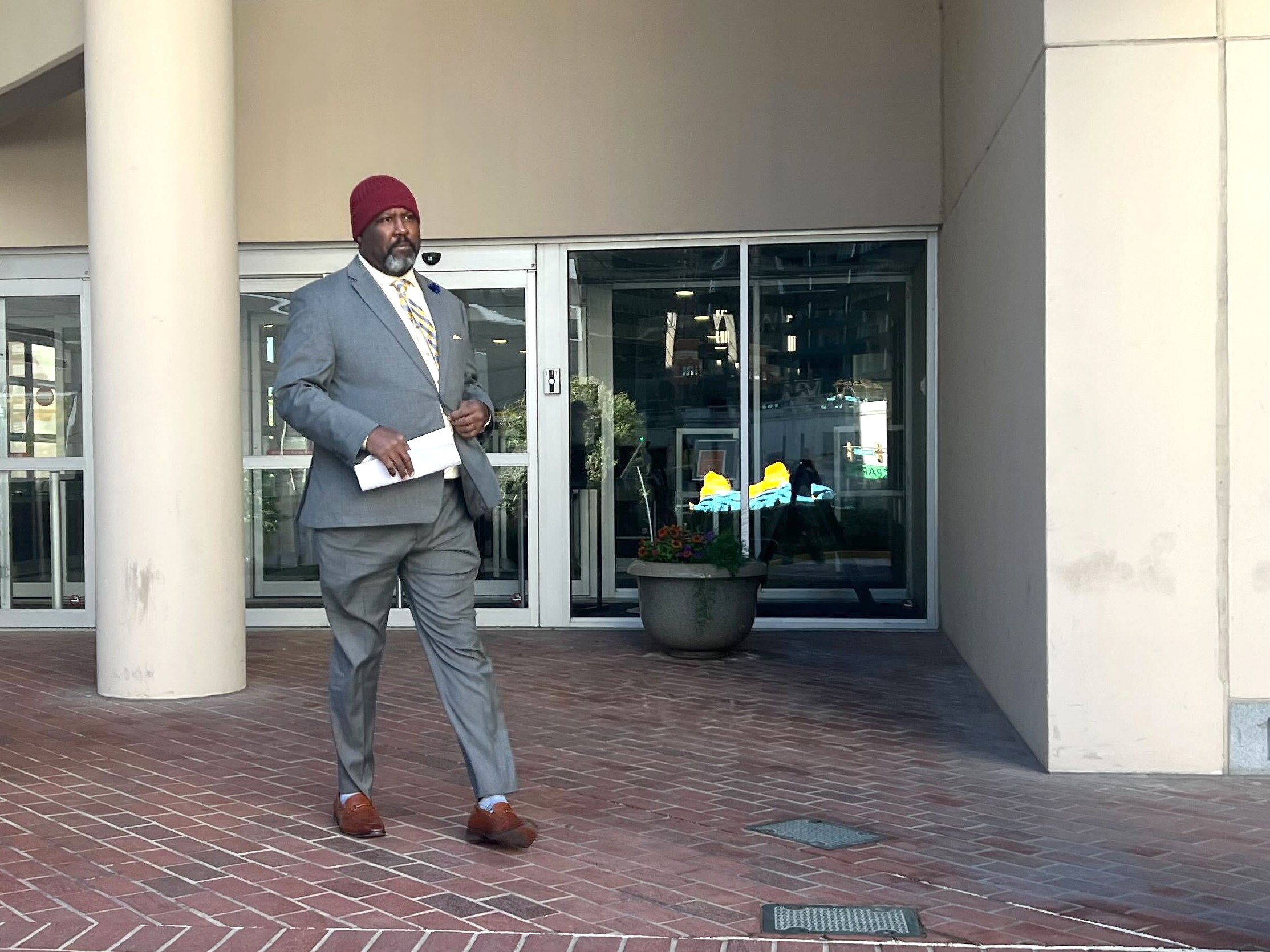 Former Dunbar football coach Lawrence Smith leaves US District Court in Baltimore on Friday afternoon after pleading guilty to wire fraud and tax evasion related to $215,000 in overtime pay he collected as a city schools police officer for hours that he did not actually work.