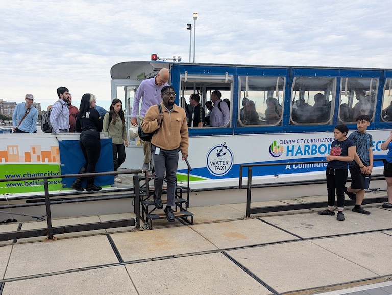 Passengers disembark from the Harbor Connector in Locust Point, a point-to-point ferry service in Baltimore supported by the city.