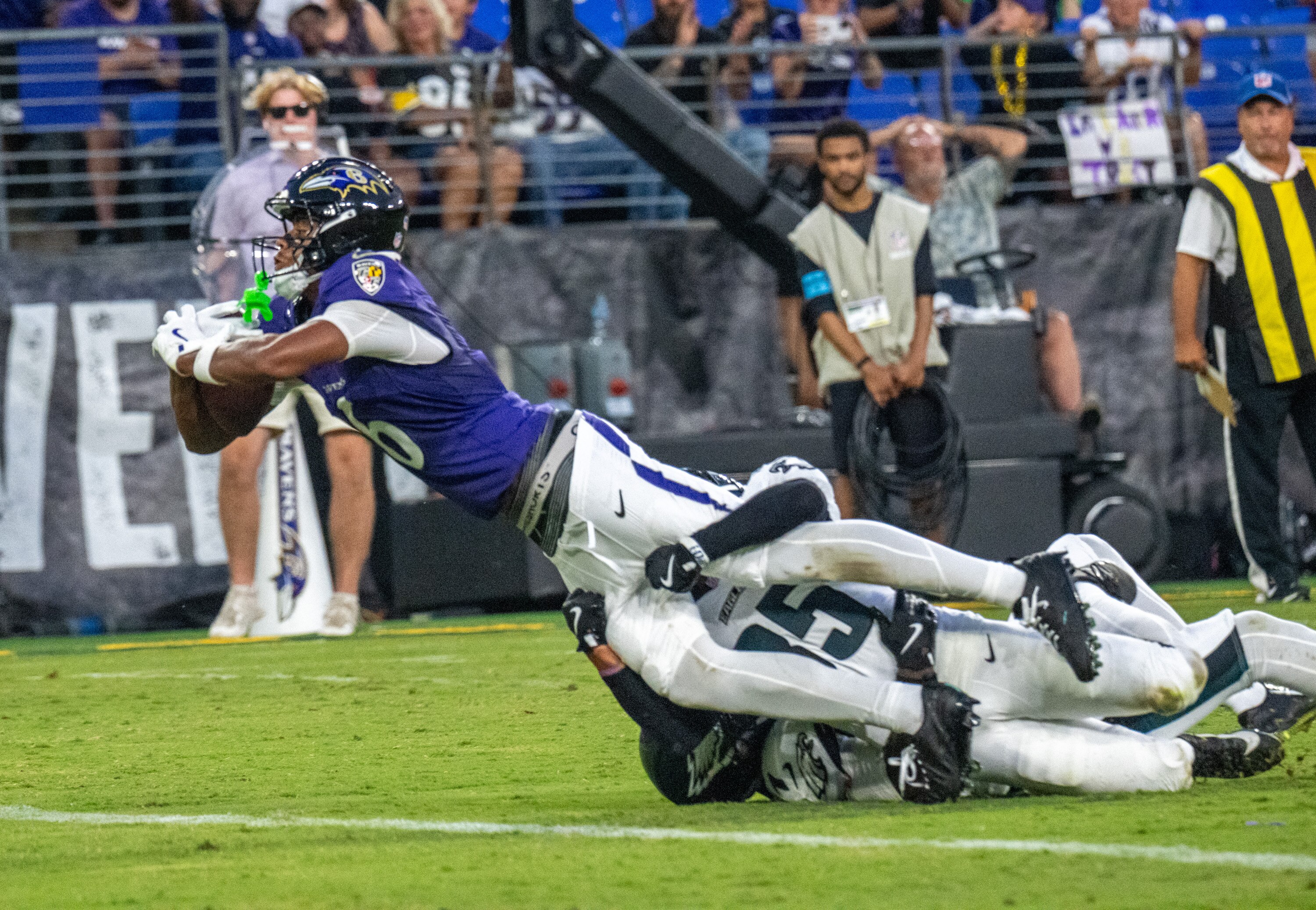 Ravens wide receiver Ja’Kobi Lane dives into the end zone for a 16-yard touchdown reception in the second quarter Saturday night.
