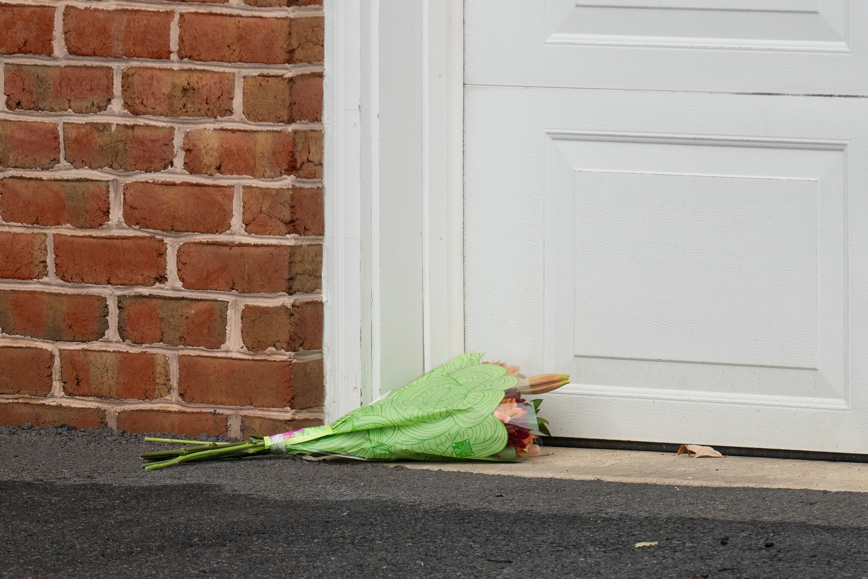 Flowers are placed next to the garage door in the driveway of the home of Maryland Circuit Court Judge Andrew Wilkinson, Friday, Oct. 20. 2023, in Hagerstown.