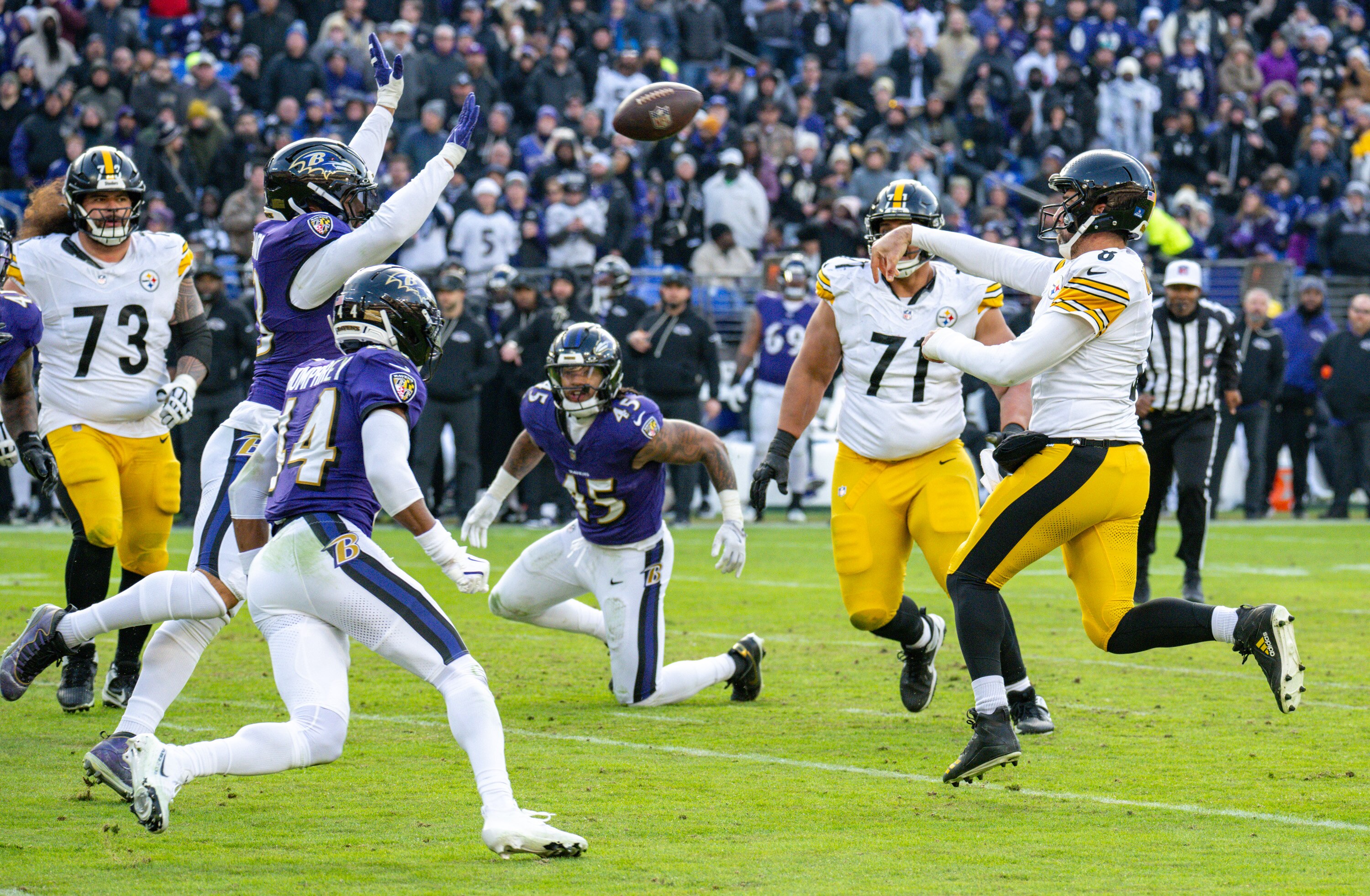 Pittsburgh Steelers quarterback Aaron Rodgers (8) throws incomplete under pressure from Baltimore Ravens linebacker Kyle van Noy (53) and cornerback Marlon Humphrey (44) in the thirds quarter as the Ravens host the Pittsburgh Steelers at M&T Bank Stadium.