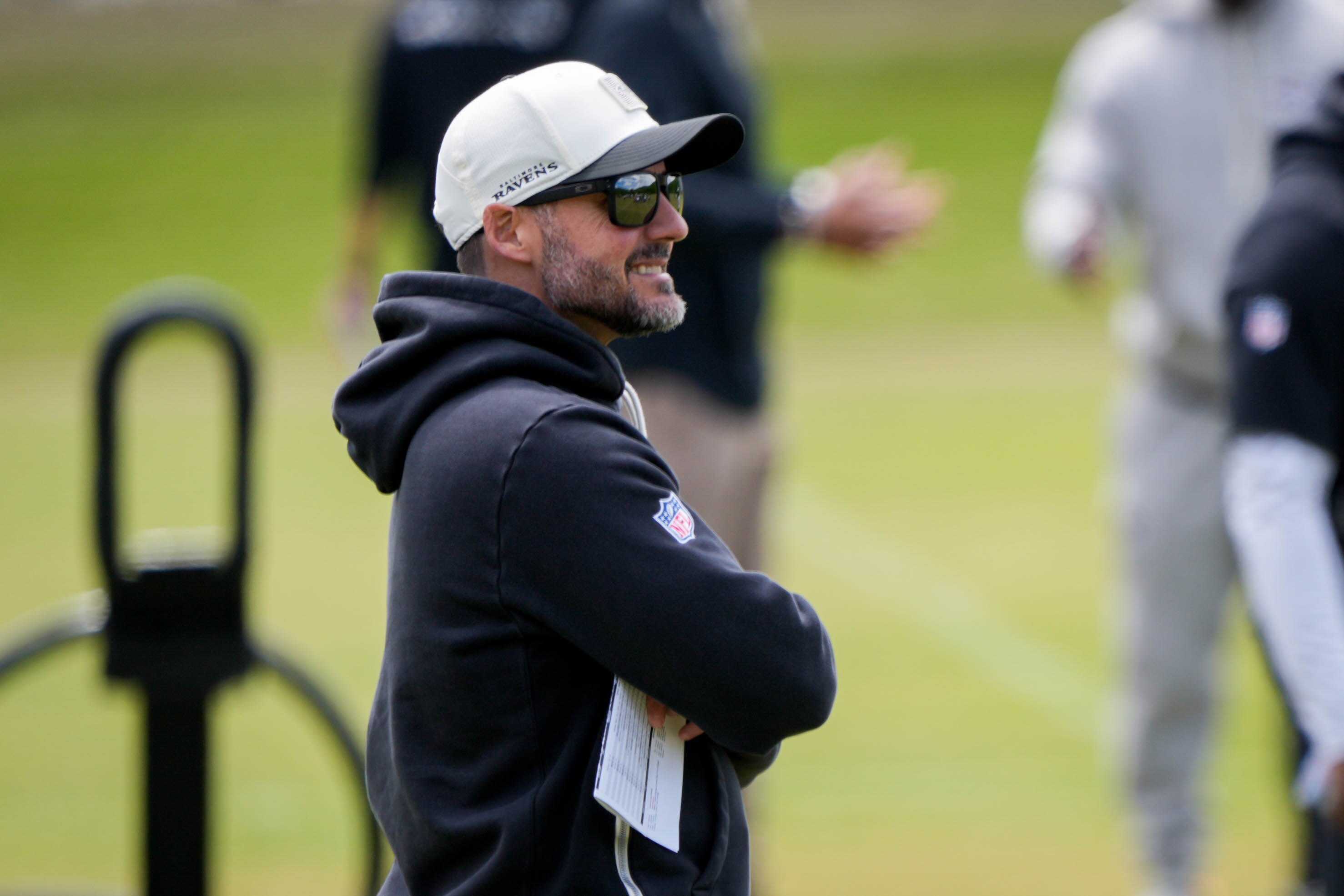 Ravens head coach Jesse Minter watches as his team warms up during rookie minicamp practice in early May.