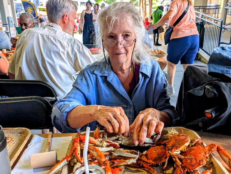 Mary Lou Polk learned to pick a crab 75 years ago from her father. She enjoyed several trays full on Aug. 7, 2026 at the annual Annapolis Rotary Crab Feast.