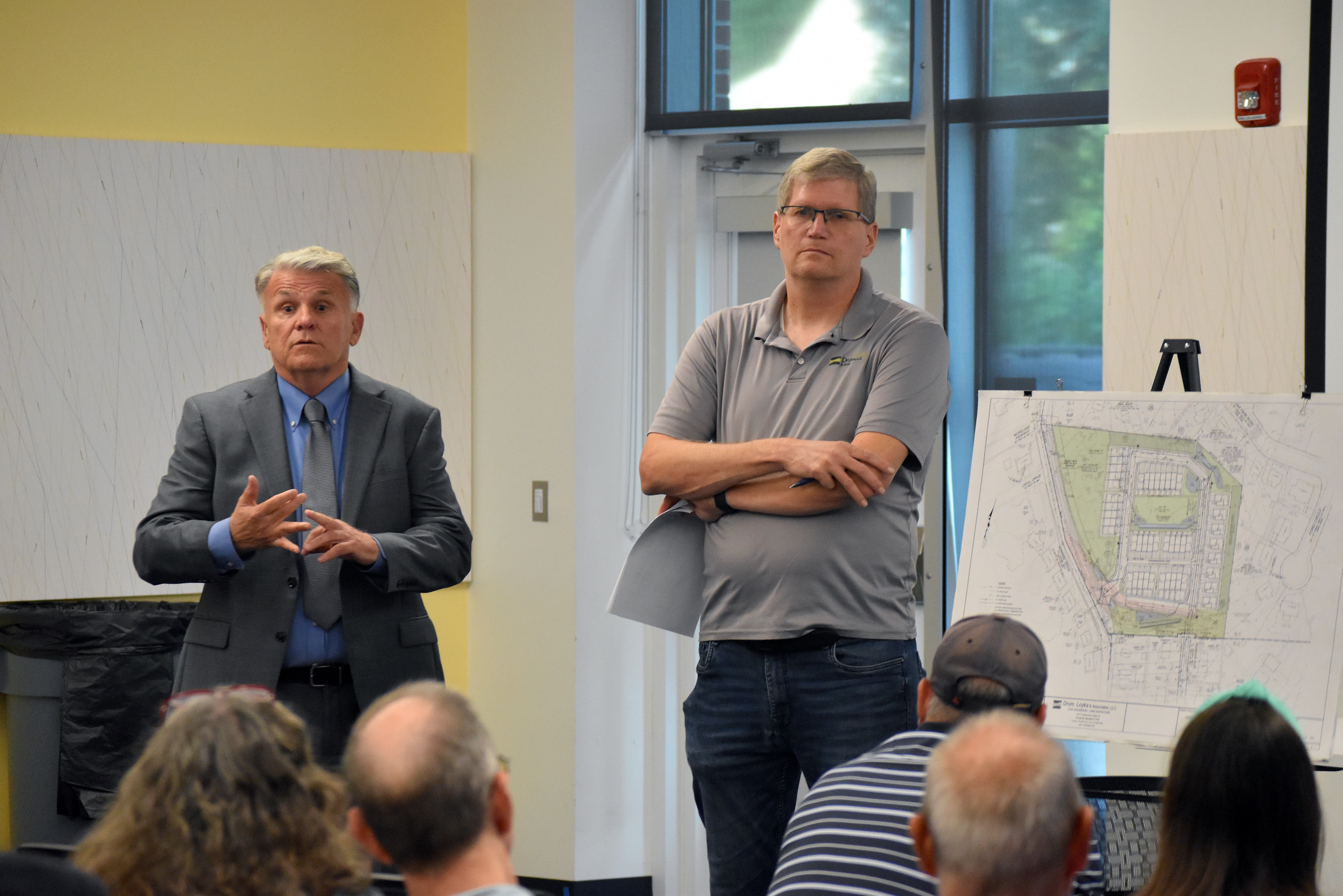 Bill Coyne, the owner of  236 Admiral Drive, and Bob McCarthy, an engineer working on a development plan for the plot of land, address community questions at a public meeting at the Michael E. Busch Annapolis Library on Wednesday, Sept. 2, 2026.