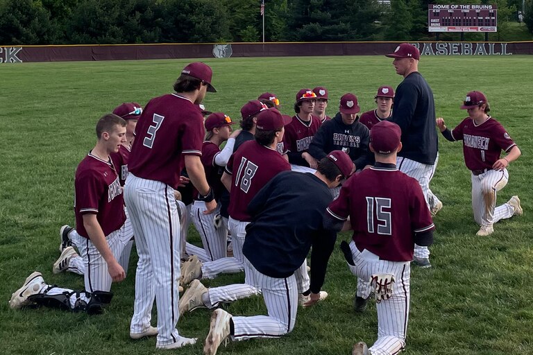 Broadneck baseball coach Matt Skrenchuk (standing) talks to his team after Monday's victory over Glen Burnie. The No. 3 Bruins remained in first in the Anne Arundel County standings with a 8-1 victory over Glen Burnie in Cape St. Claire.