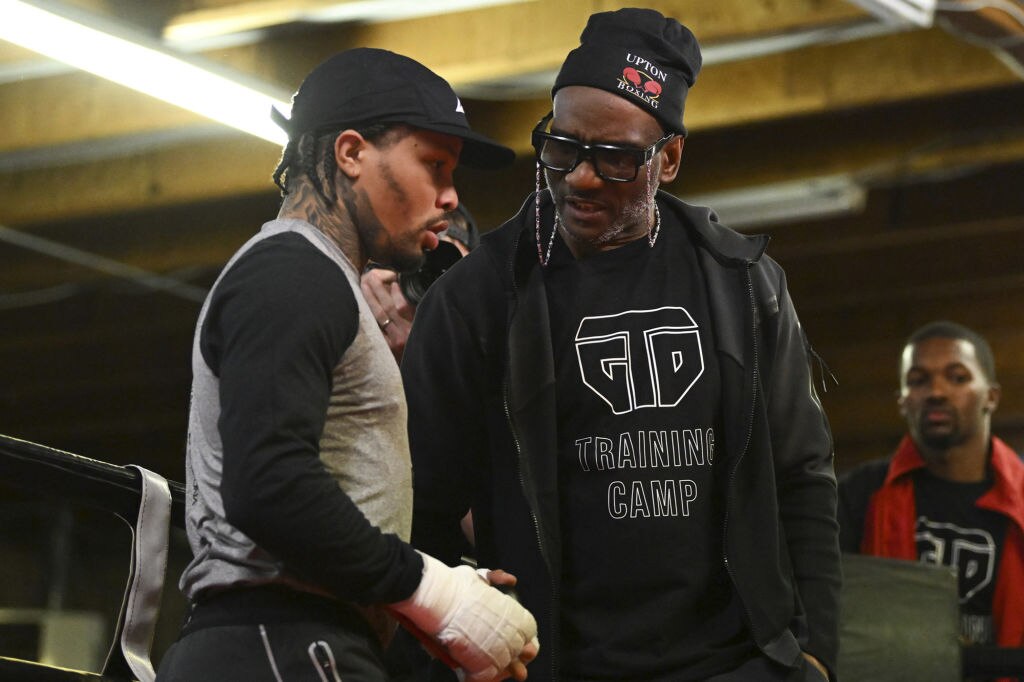 WBA lightweight champion Gervonta Davis, left, speaks to his head trainer, Calvin Ford, in the ring during a workout at Barry's Boxing Gym on April 6 in Las Vegas.
