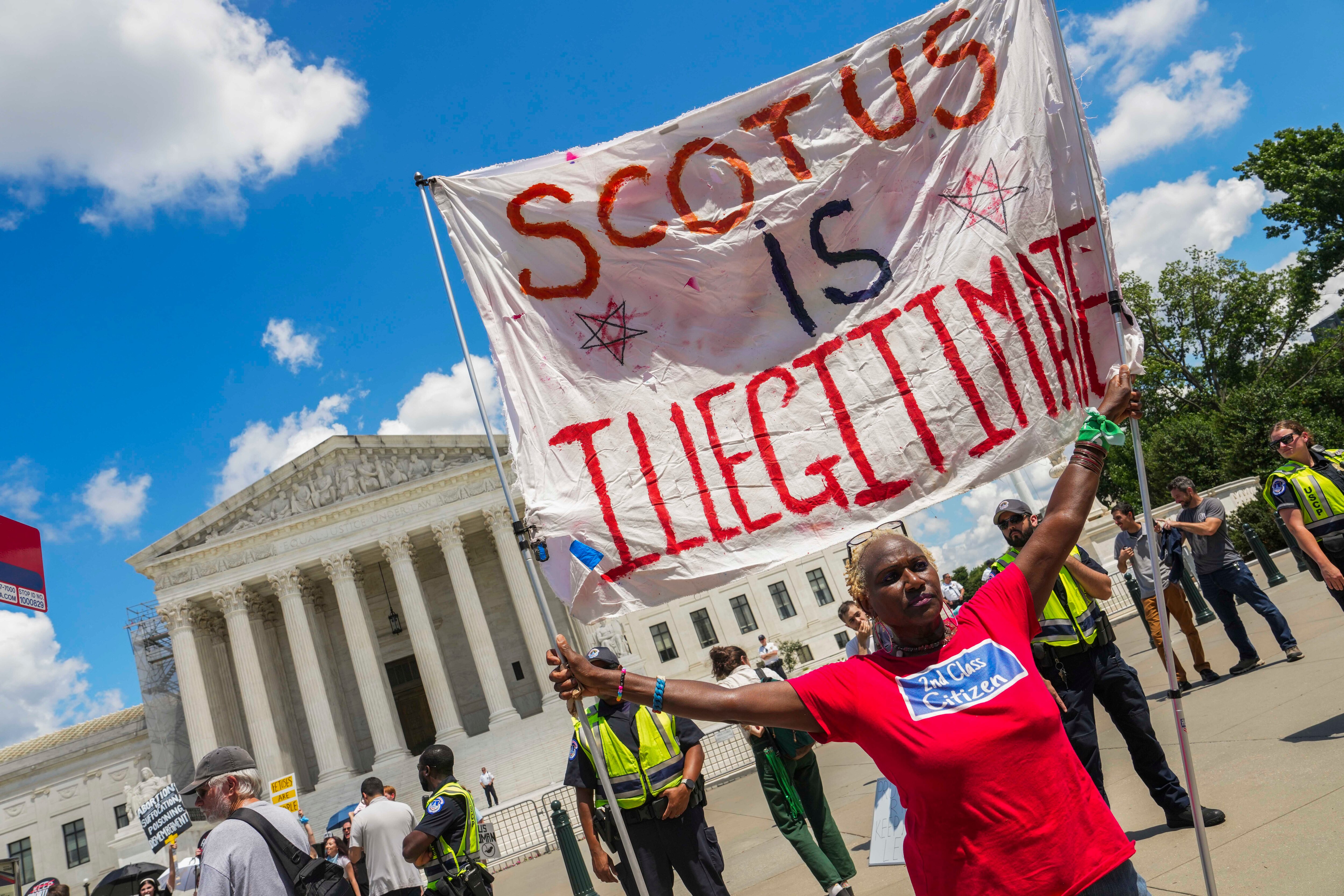 Nadine Seiler holds up a sign in front of SCOTUS at the Women’s March on the anniversary of the overturn of Roe v Wade on June 24, 2023.
