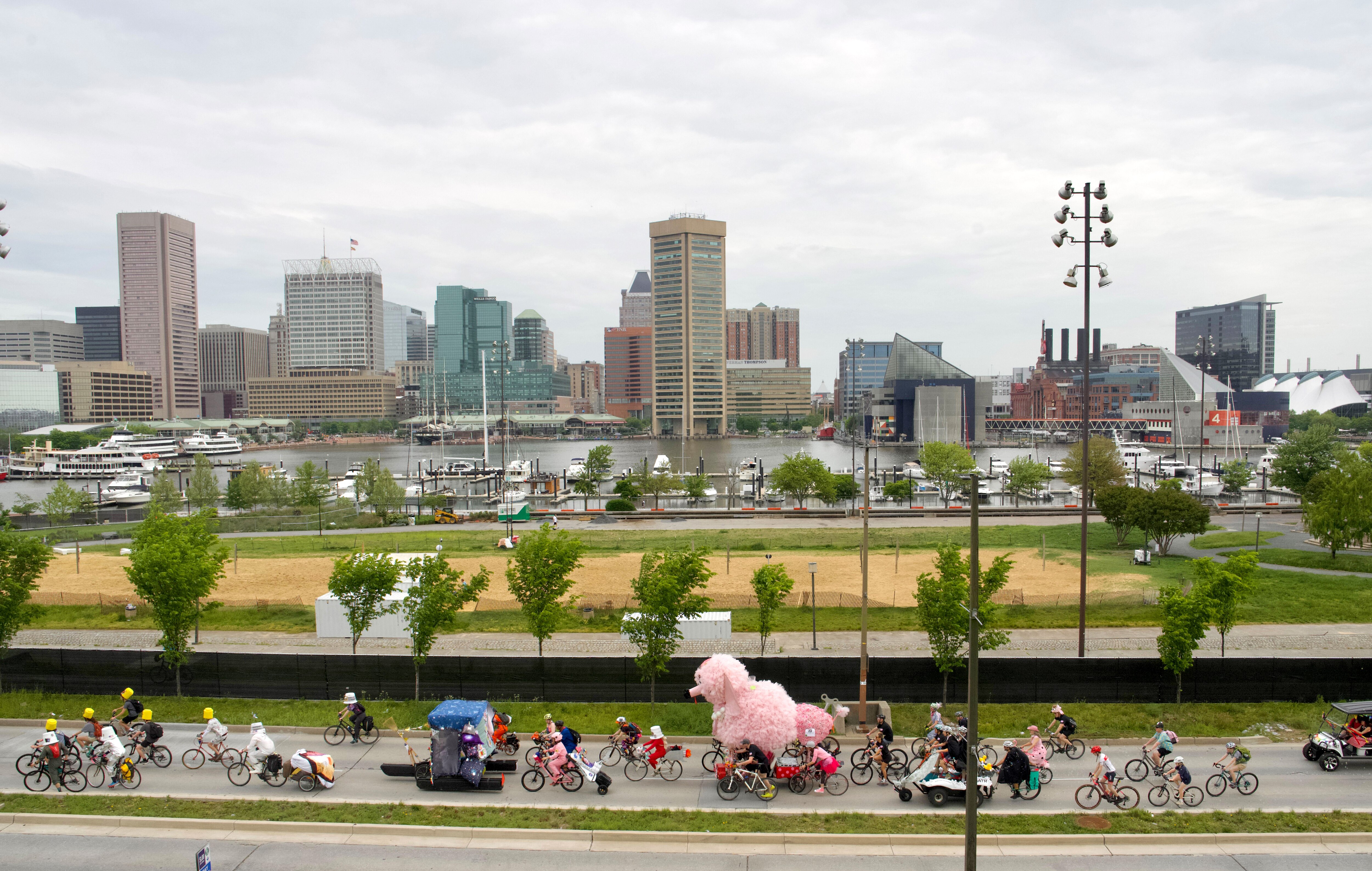 FiFi the Poodle, center, the race’s heaviest sculpture, makes her way down Key Highway to kick off the Kinetic Sculpture Race on Saturday.