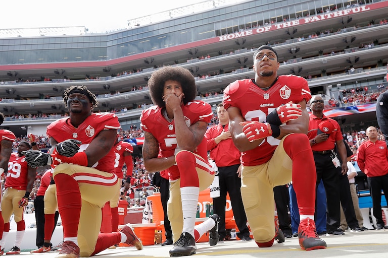 FILE - In this Oct. 2, 2016, file photo, from left, San Francisco 49ers outside linebacker Eli Harold, quarterback Colin Kaepernick and safety Eric Reid kneel during the national anthem before an NFL football game against the Dallas Cowboys in Santa Clara, Calif. (AP Photo/Marcio Jose Sanchez, File)