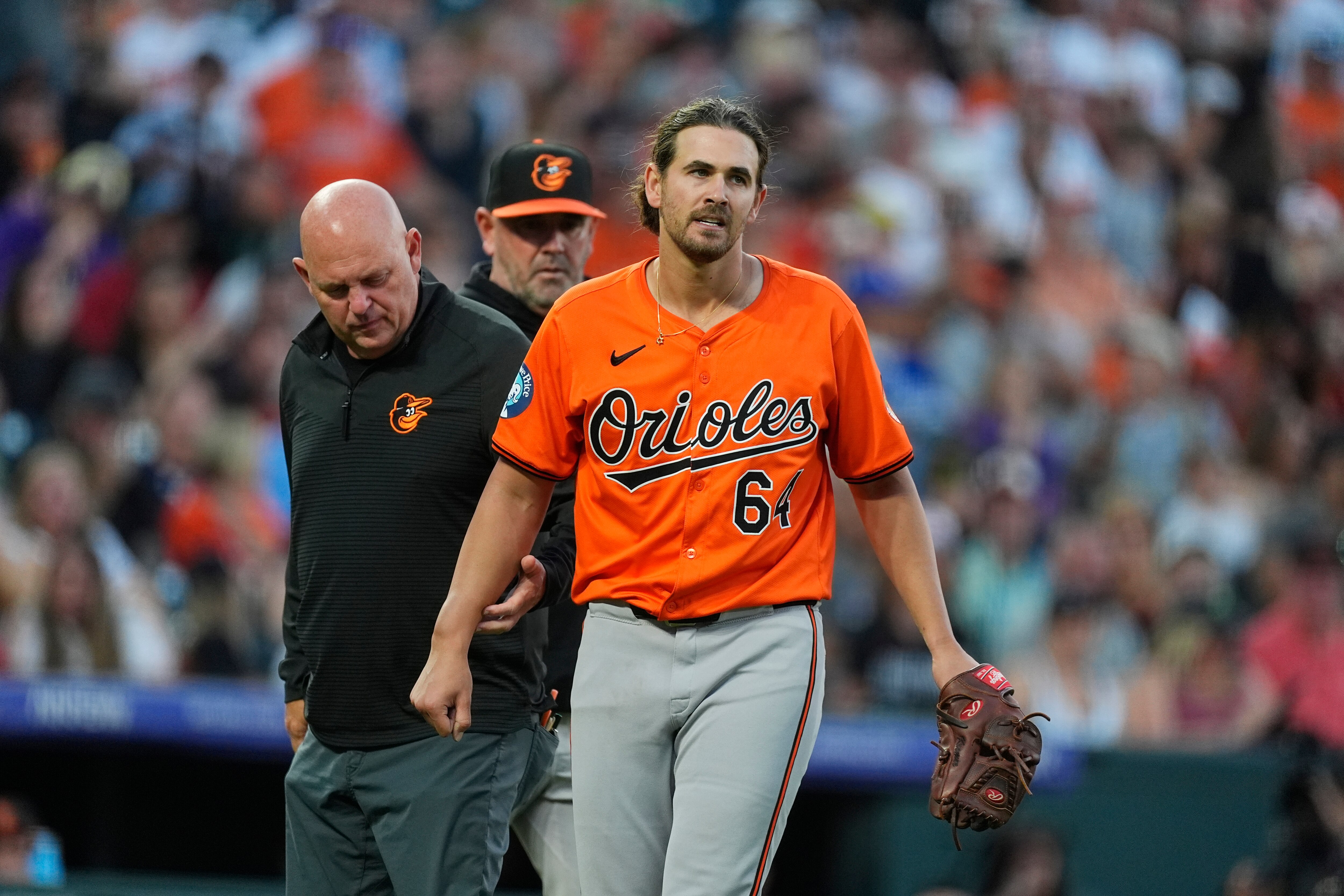 Dean Kremer prepares to leave the game after being hit by a ball off the bat of the Rockies’ Jordan Beck in the fourth inning Saturday night.