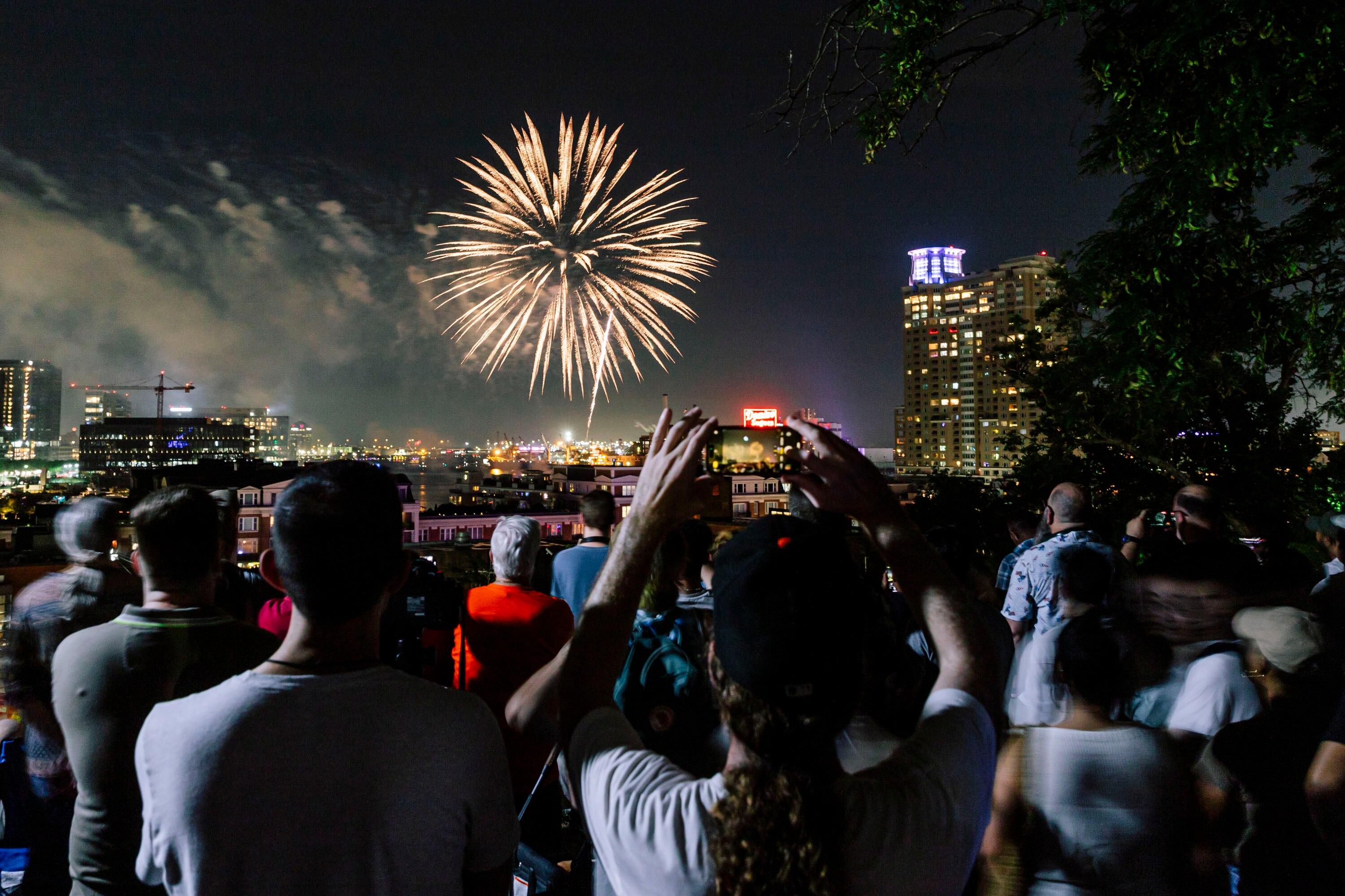 A crowd watches fireworks for the Fourth of July from Federal Hill Park on Thursday, July 4, 2024 in Baltimore, MD.