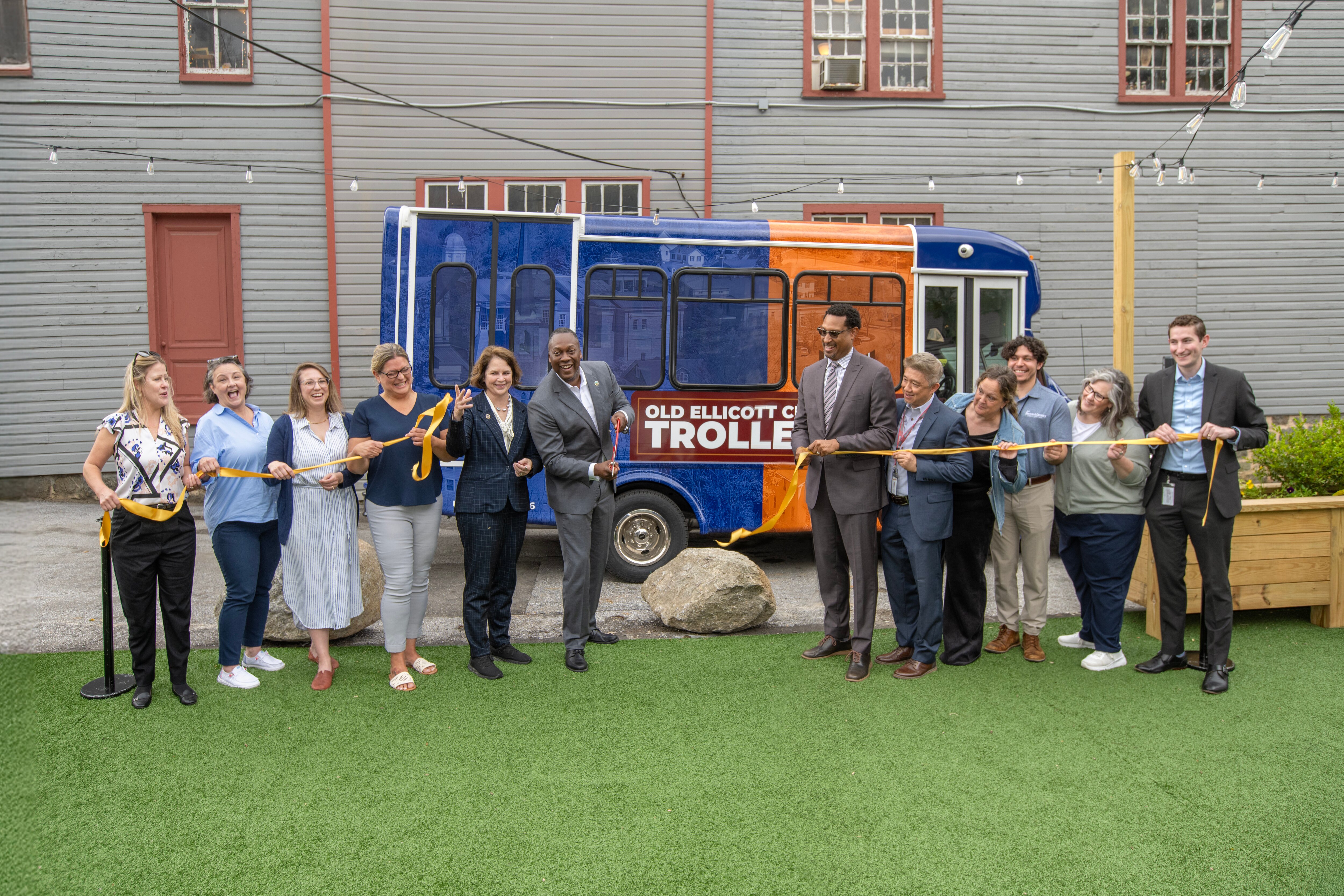 Howard County Executive Calvin Ball, center left, joins others to launch the public “trolley” service in Old Ellicott City on Thursday, May 15, 2025.