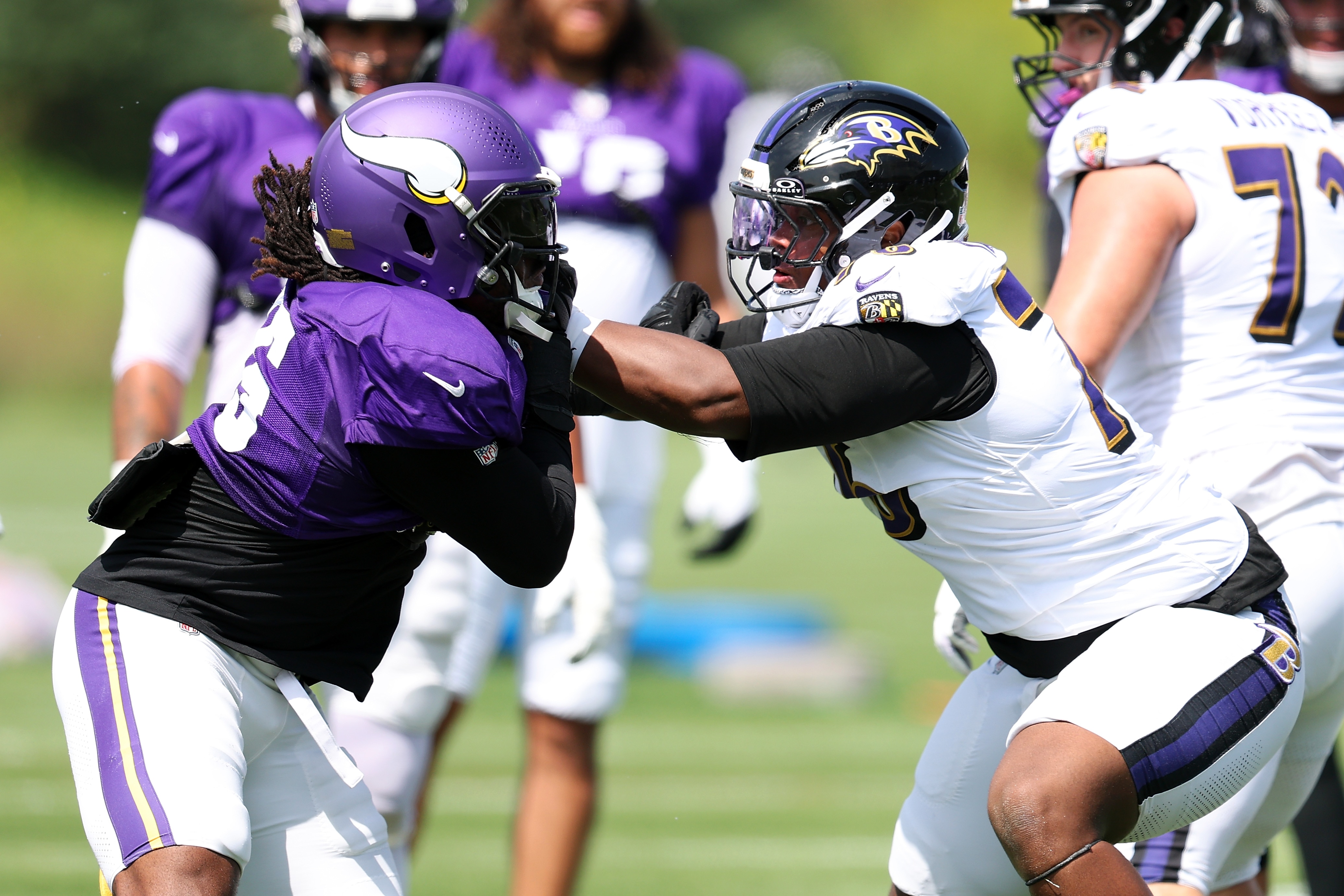 Dallas Turner of the Vikings and John Simpson of the Ravens participate in a drill during a joint practice Wednesday in Minnesota.