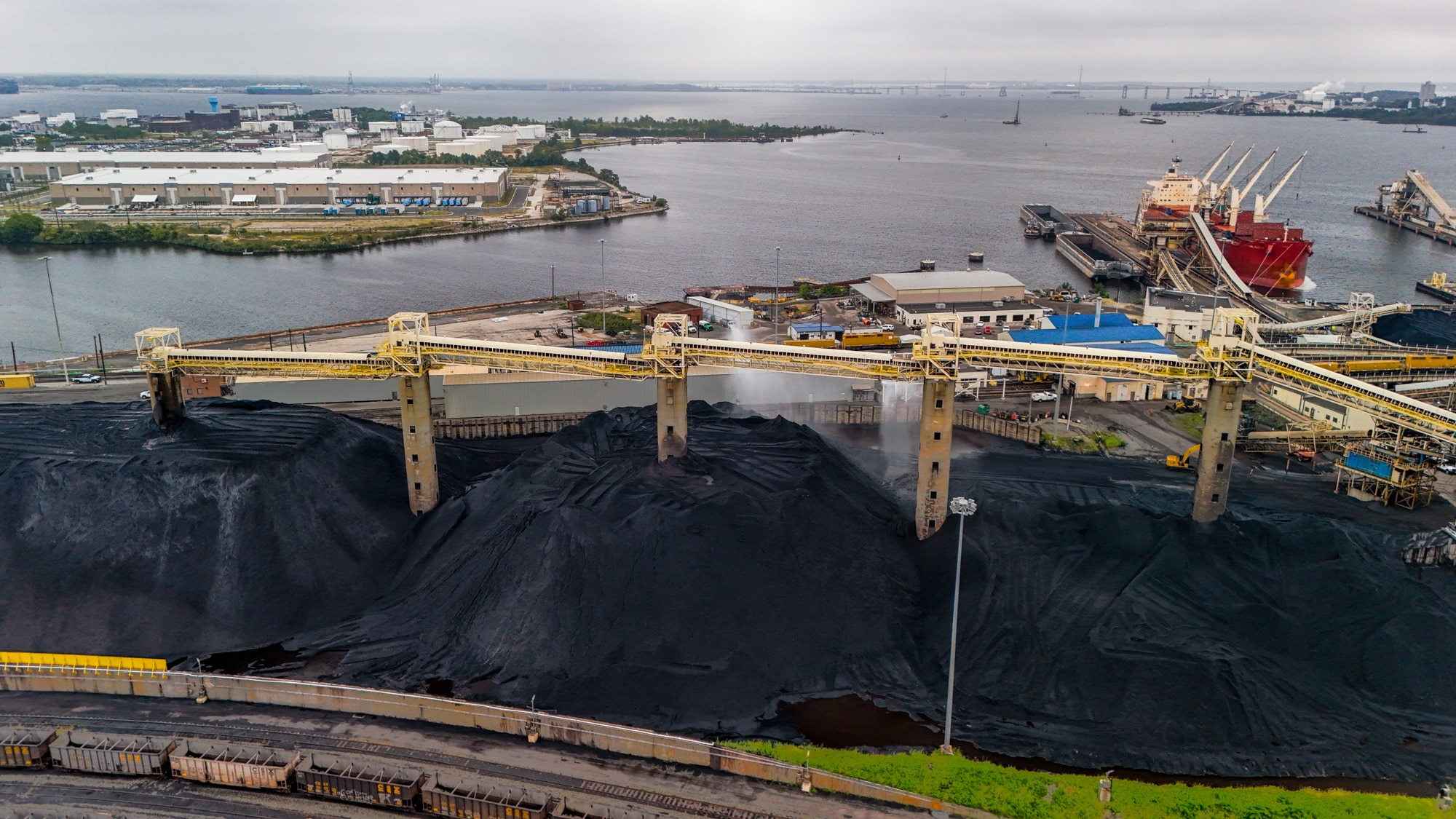 Water is sprayed on the massive piles of coal at the Curtis Bay coal piers operated by CSX Transportation.