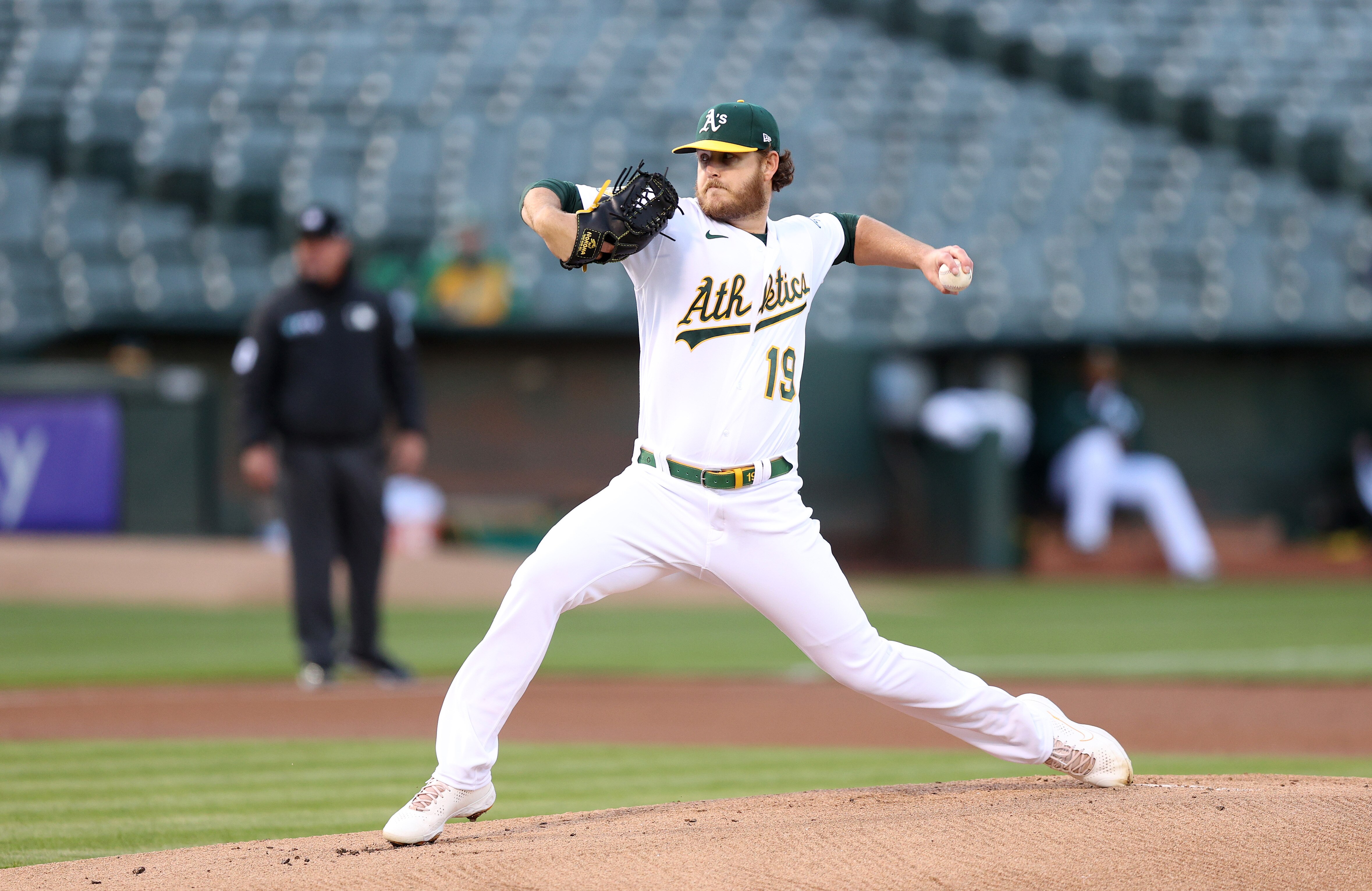 Cole Irvin, then with the Athletics, pitches against the Orioles before a sparse crowd in a 2022 game in Oakland.