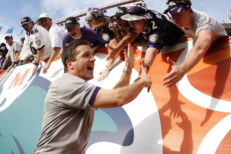 MIAMI - JANUARY 04: Head coach John Harbaugh of the Baltimore Ravens celebrates a 27-9 AFC Wild Card victory over the Miami Dolphins with fans on January 4, 2009 at Dolphin Stadium in Miami, Florida.