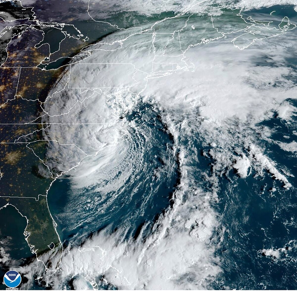 This satellite image from 8:16 a.m. Saturday, provided by the National Oceanic and Atmospheric Administration, shows Tropical Storm Ophelia making landfall in North Carolina.