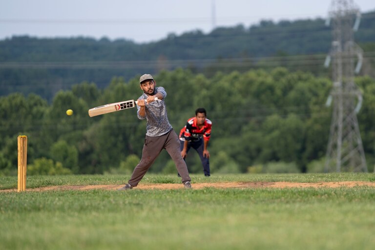 A cricket player takes his turn at the bat during practice July 27. Players switch positions so most members can train in different roles.