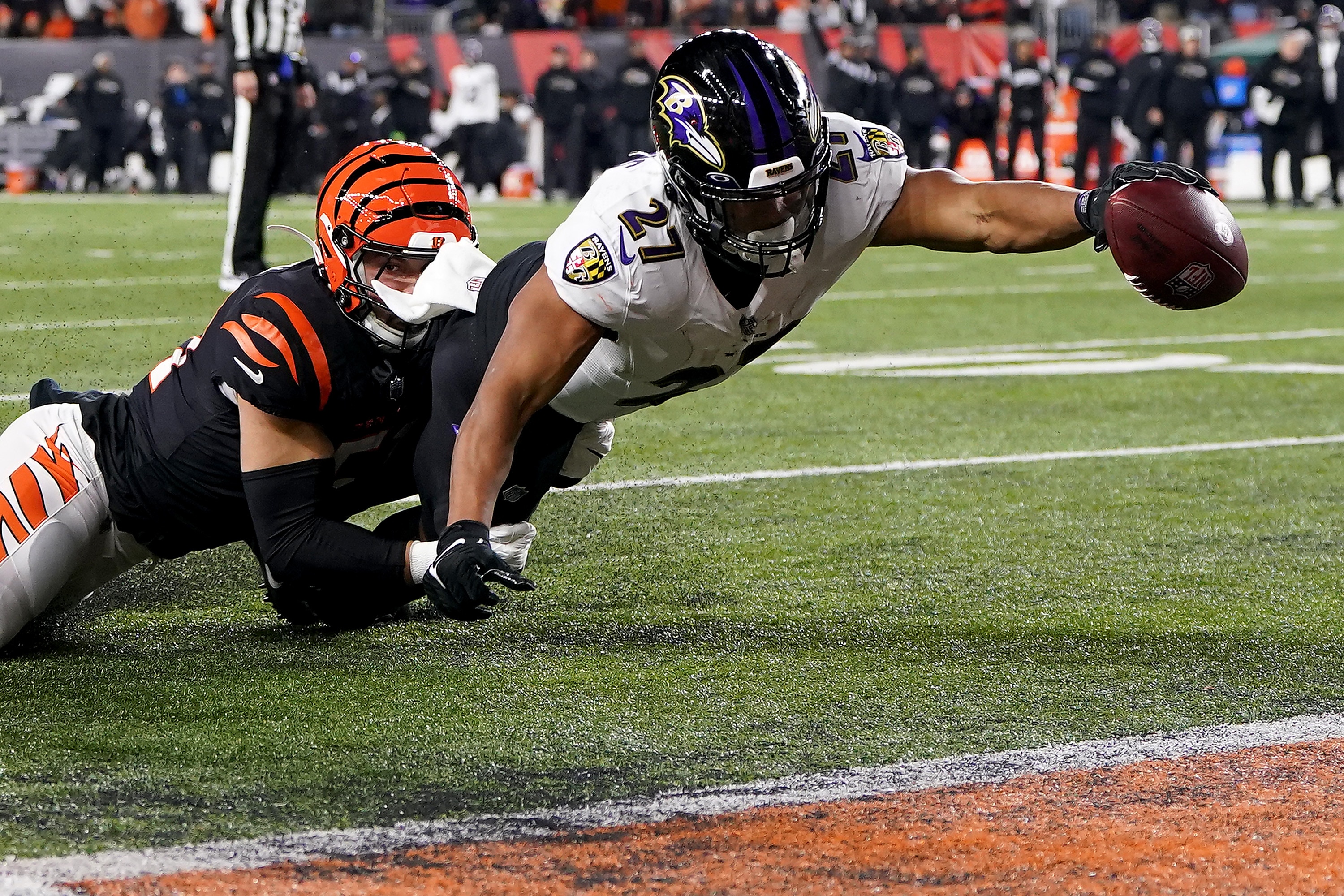 CINCINNATI, OHIO - JANUARY 15: J.K. Dobbins #27 of the Baltimore Ravens dives to end zone to score a two yard touchdown against Markus Bailey #51 of the Cincinnati Bengals during the second quarter in the AFC Wild Card playoff game at Paycor Stadium on January 15, 2023 in Cincinnati, Ohio. (Photo by Dylan Buell/Getty Images)